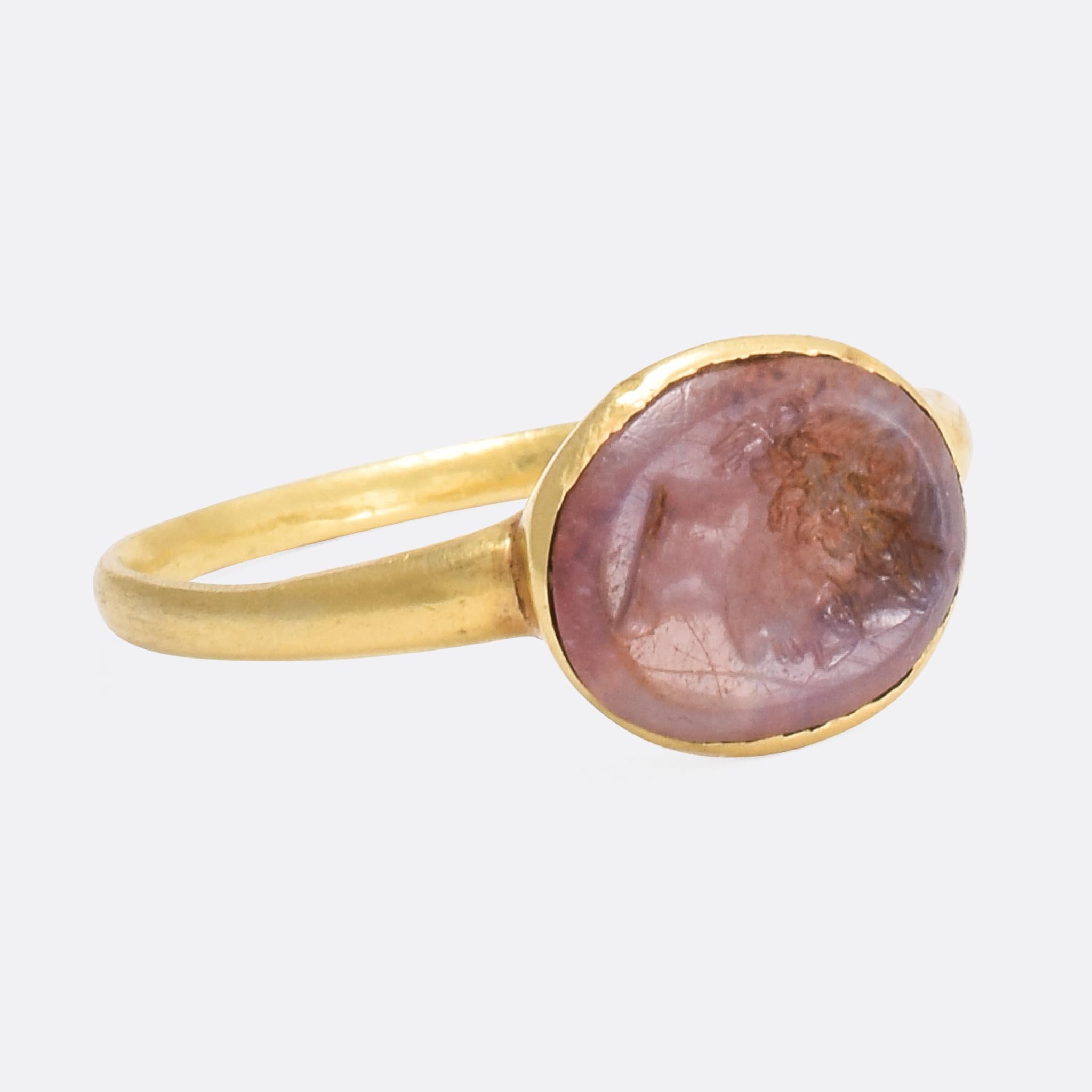 An exceptional antique signet ring, home to a Roman era intaglio panel carved with the head Emperor Caesar Augustus. The detail to the carving is really quite amazing, the Emperor is crowned with a laurel leaf with a bow to the back of his