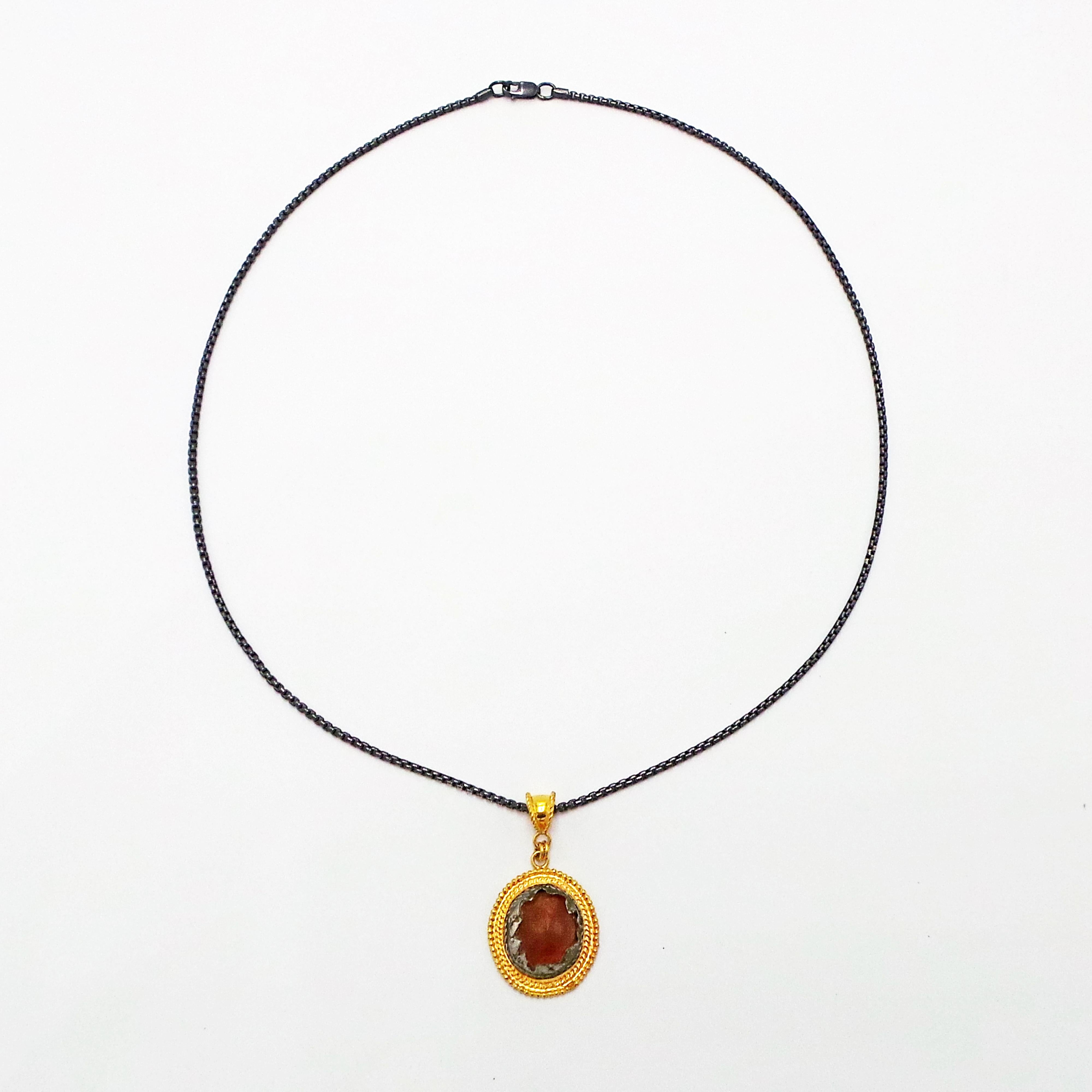 Authentic ancient Roman carved Carnelian gemstone encased in original ancient silver mounting (1st-3rd century AD), and set in custom 22k yellow gold rope design pendant. Pendant is on an 18 inch oxidized sterling silver box chain. Very rare and