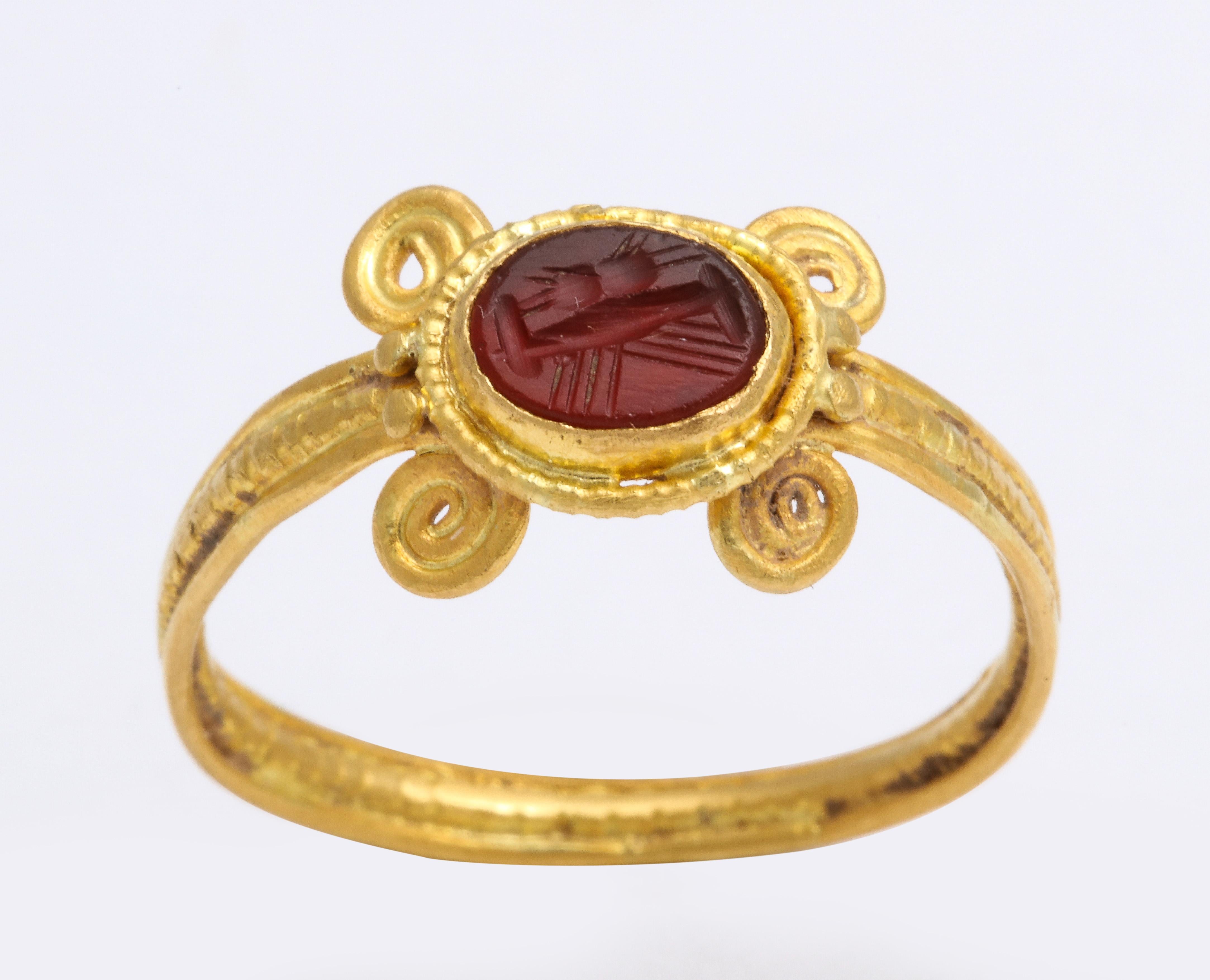 We are proud to show this circular hoop of 22 Kt gold, with coiling around the shoulders, sets an oval shaped intaglio