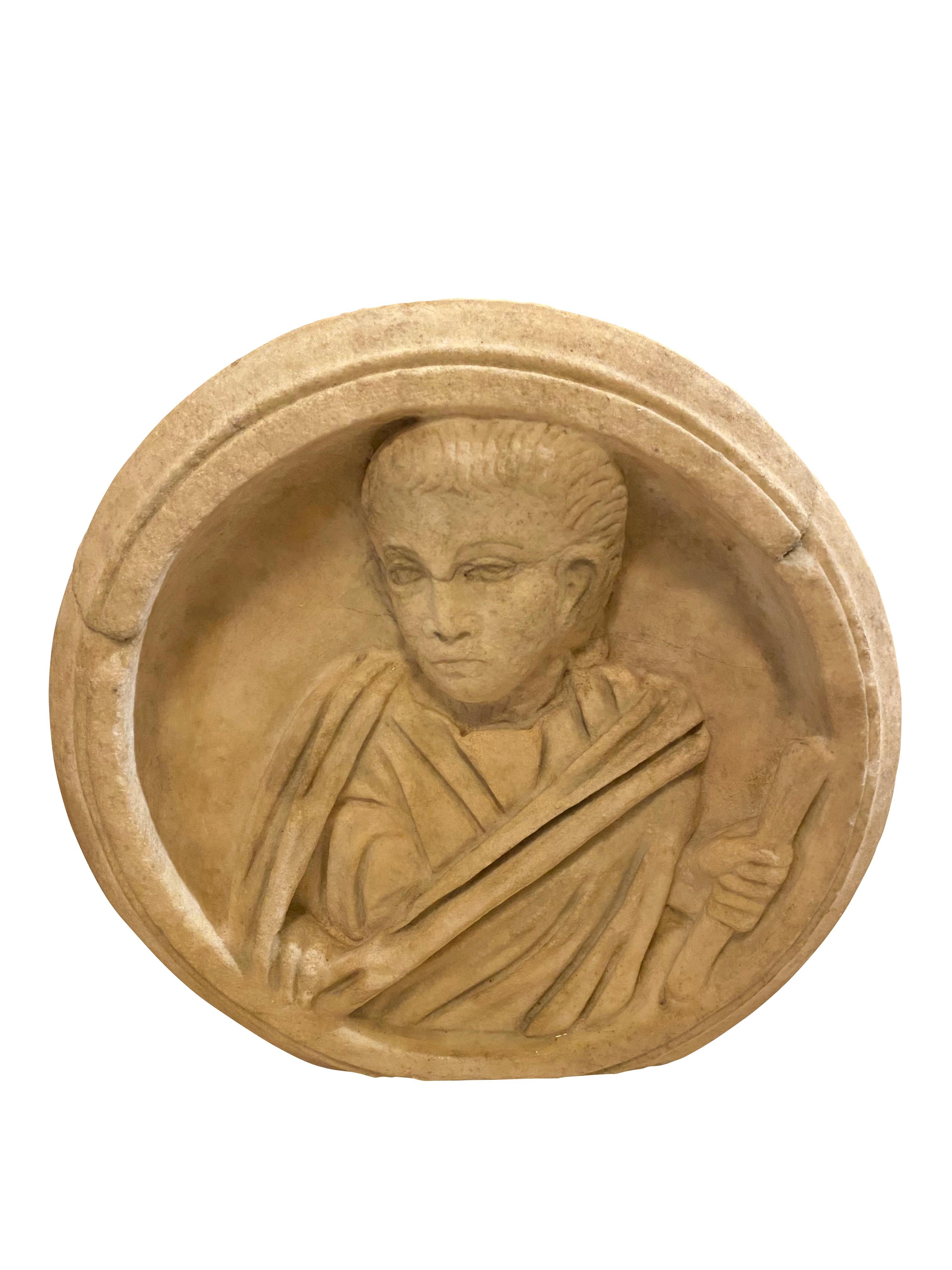 Depicting a robed man holding a scroll in a circular frame. Purchased in Southern California.