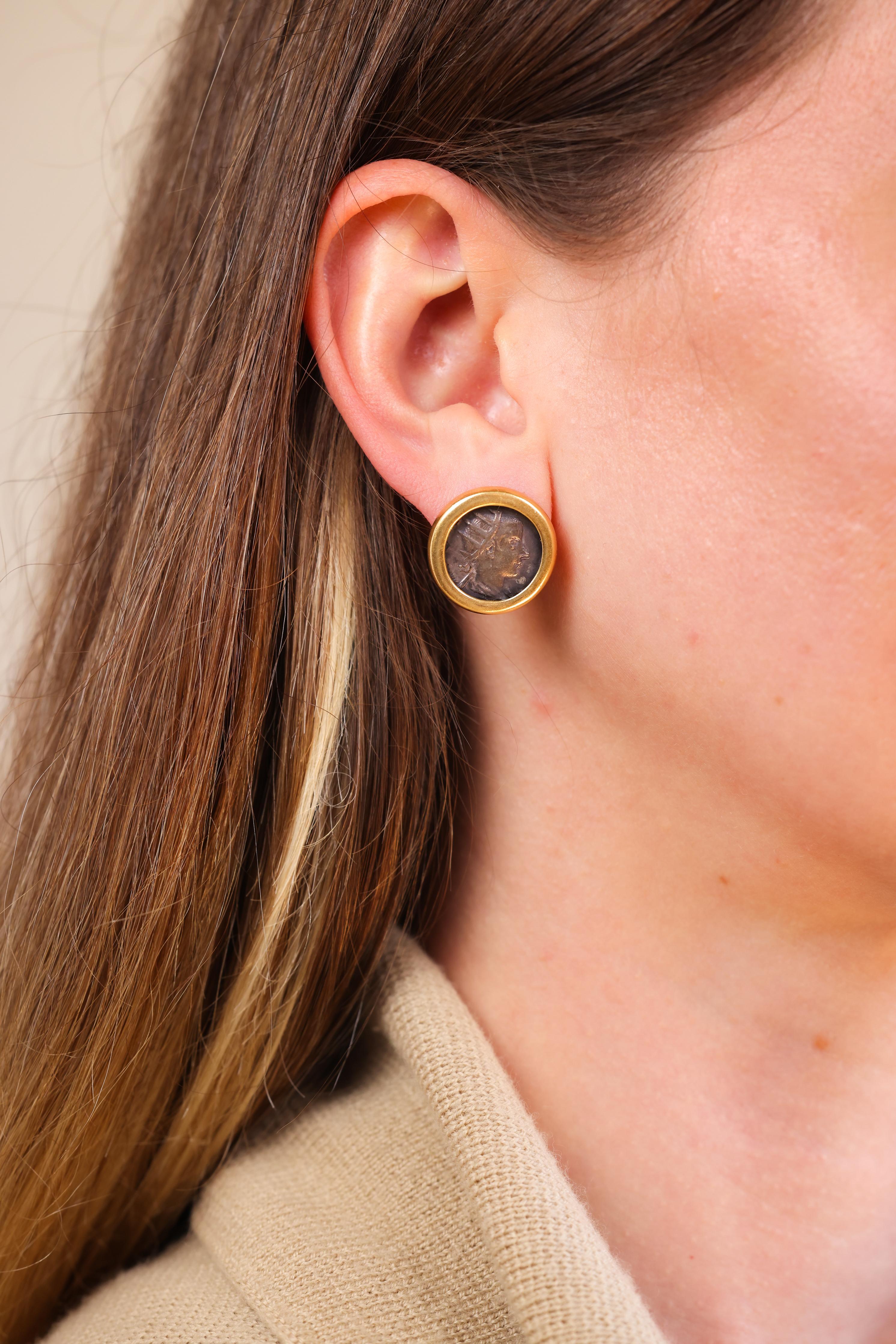 Ancient Roman Coins 
18k yellow gold 
Circa 1980s 
3/4 inches long 
3/4 inches wide 
15.6 grams 


Step into a piece of history with these unique earrings featuring authentic Ancient Roman coins. Set in 18k yellow gold, these earrings from the 1980s