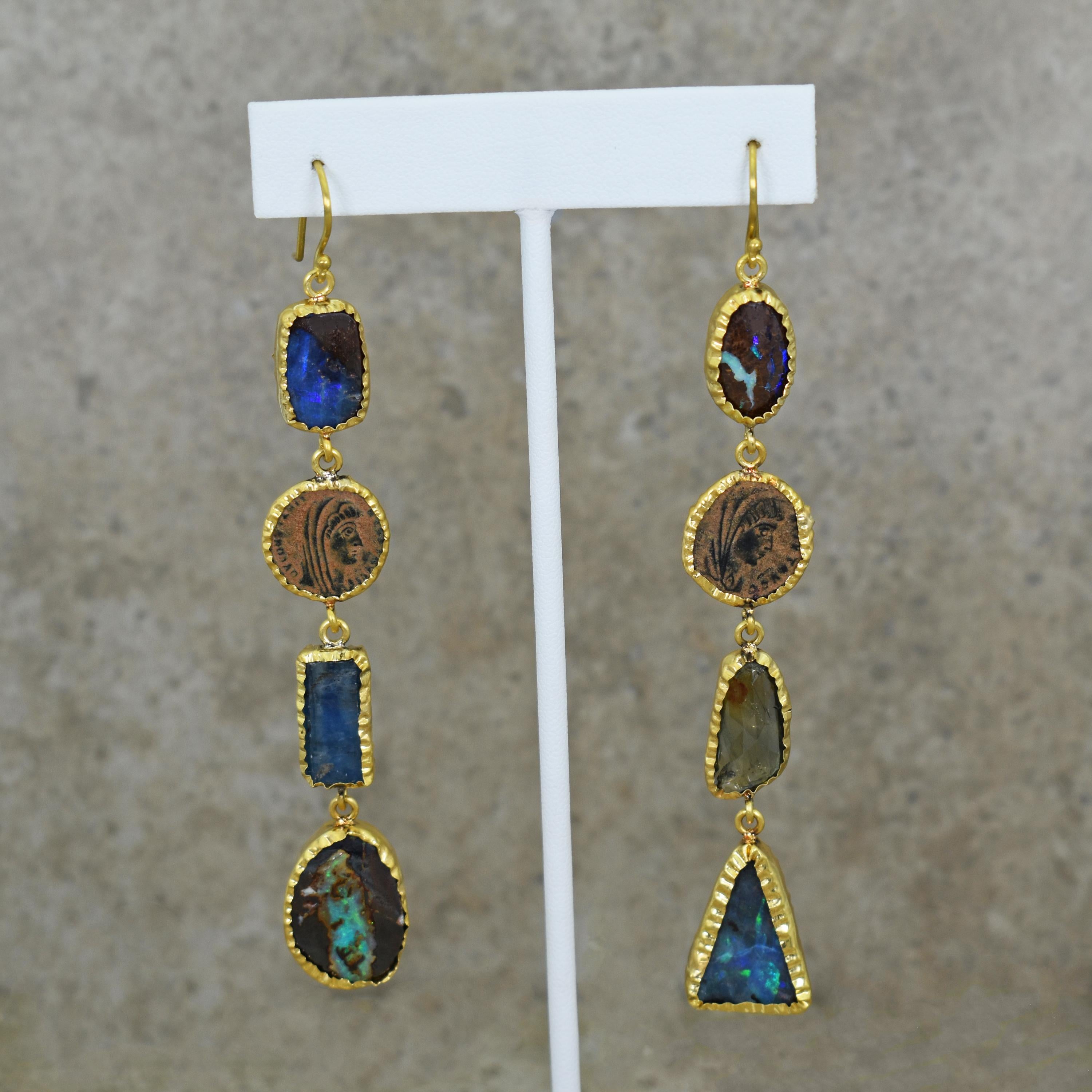 Hand-wrapped 22k yellow gold asymmetrical shoulder-duster dangle earrings featuring a variety of Australian Boulder Opals, blue and green Aquamarine, and two ancient Roman bronze coins. Roman coins include Constantine the Great 