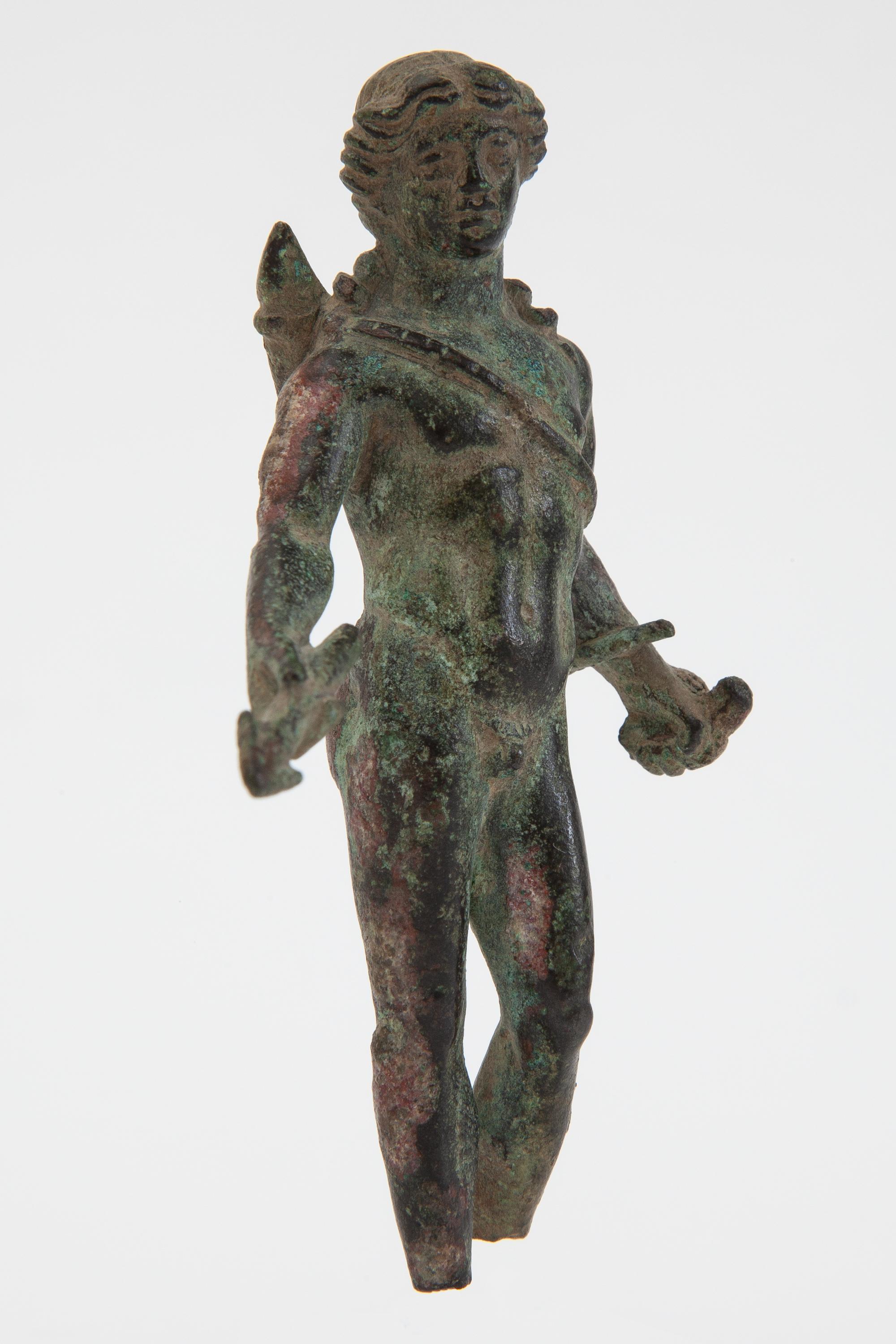 Well preserved Roman, bronze figure of Apollo with authentic patina of age. Executed as “the Hunter of Souls” with arrow, quiver and bow.
Apollo, God of transformation, prophecy, healing, light, poetry, music, magic, purification, death. Hunter of