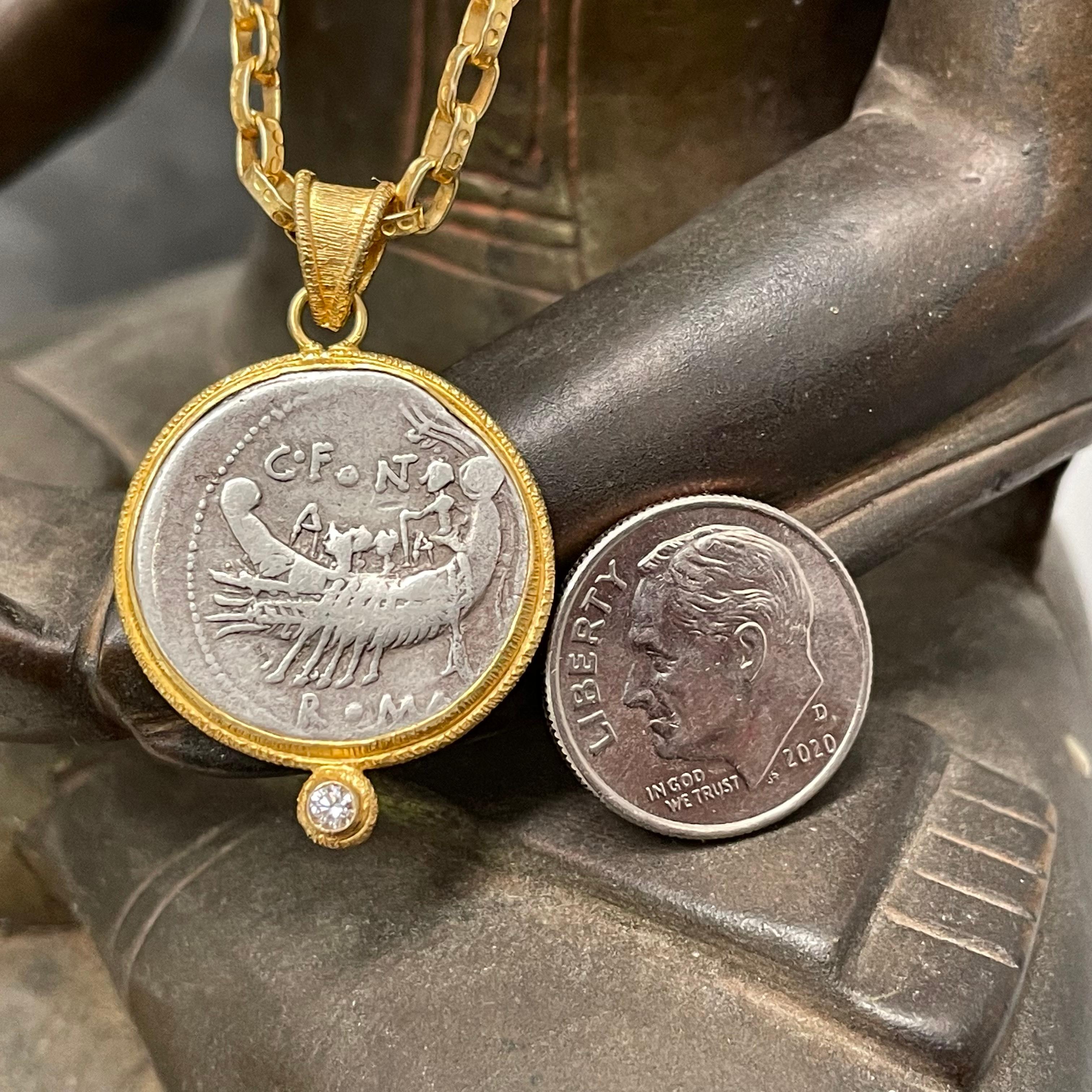 A fascinating authentic ancient Roman Republican silver denarius coin from 114 BC depicting a Roman war galley with rowers and pilot is set simply in an ancient-inspired Steven Battelle line texture bezel setting with a 2mm VS1 diamond accent below.
