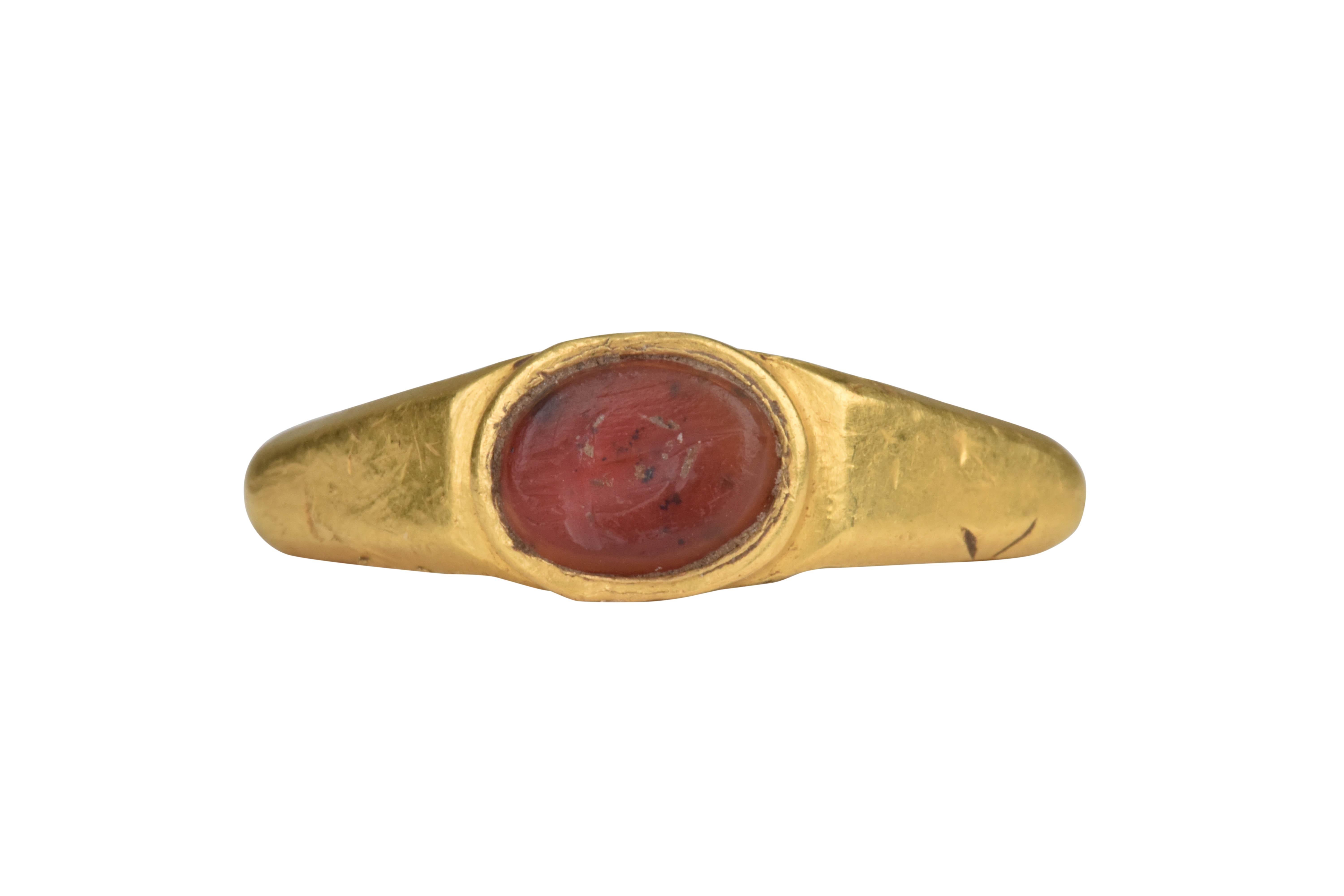 Ancient Roman Gold Intaglio Signet Ring with Cornucopia- Horn of Plenty

Ca. 100-300 AD, An Ancient Roman gold finger ring with expanding hoop, angled and facetted shoulders. Bezel set with an oval carnelian intaglio engraved with a Cornucopia - the