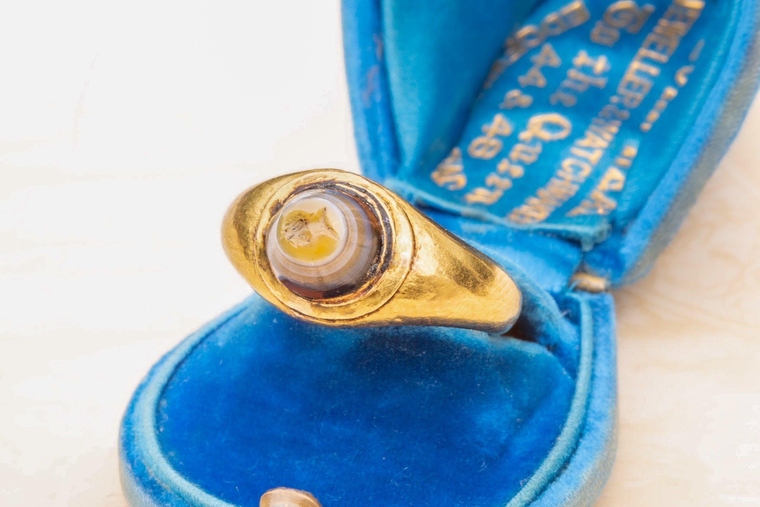 A superb ancient Roman agate intaglio ring. The high-karat gold signet ring is set with an engraved gemstone, known as an ‘intaglio’. It dates from between the 2nd to 3rd century AD and is a fine example of a Romano-British intaglio.

The