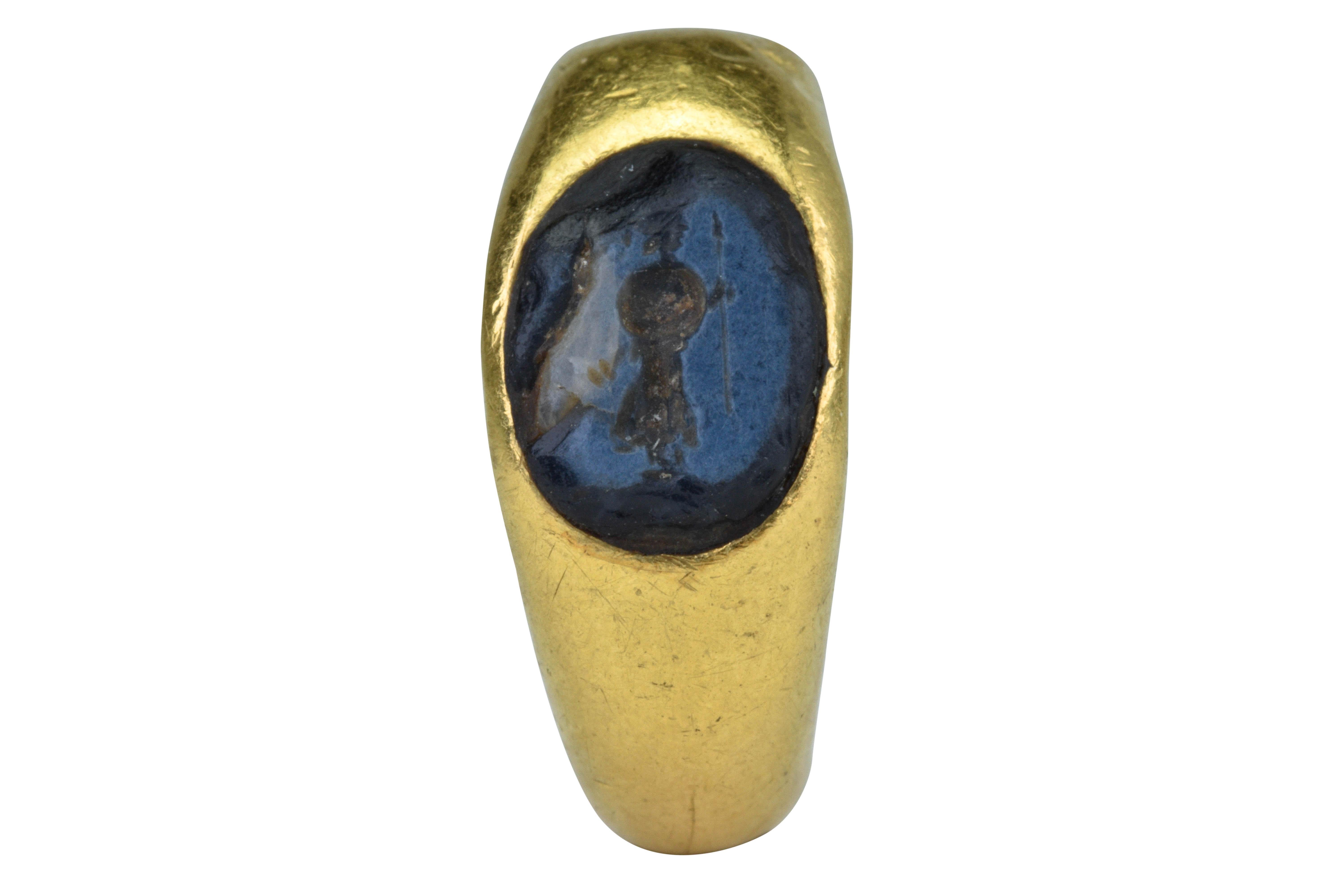 Ancient Roman Gold Nicolo Intaglio Signet Ring with Standing Warrior

Ca. 100-300 AD 

An Ancient Roman gold ring of round, smooth hoop tapering to the rear. Bezel enclosing a lovely Nicolo intaglio depicting a standing, helmeted figure of a
