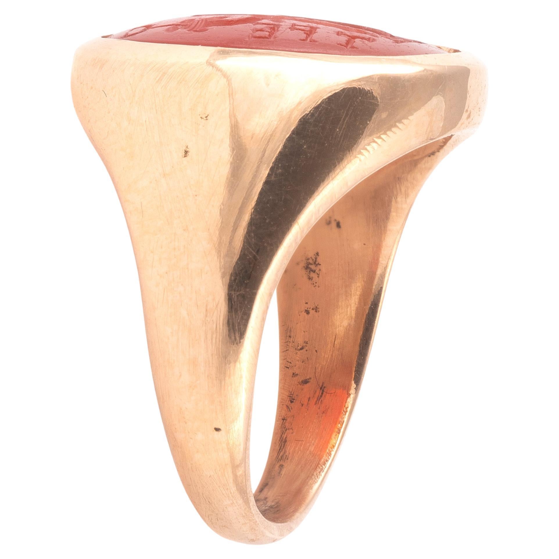An Ancient Roman hollow gold finger ring, with expanding shoulders, and an oval bezel, set with an exquisitely engraved carnelian intaglio. 
Fortuna is depicted on the intaglio, she is the Roman goddess of chance, elegantly dressed and carved. She