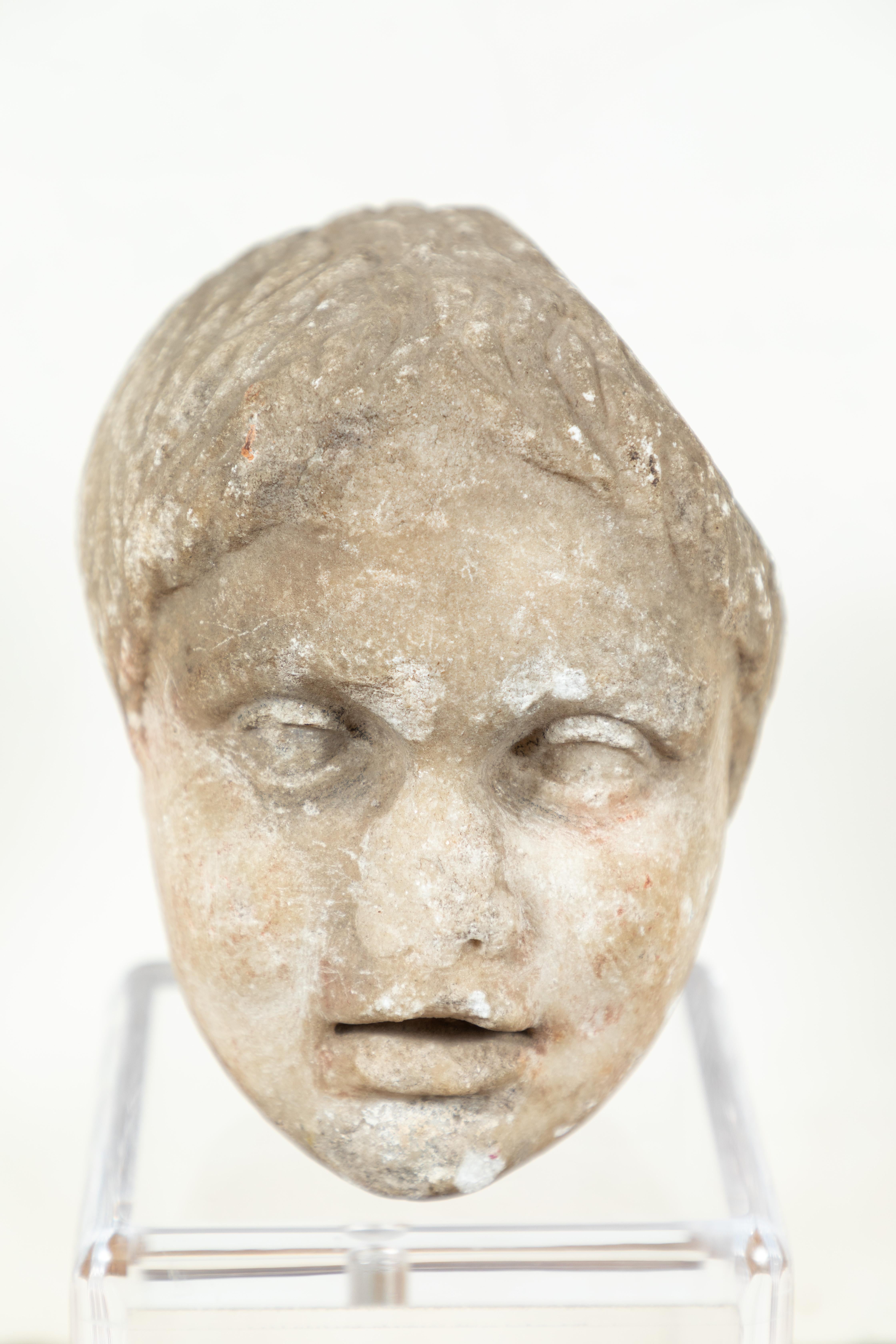 Sensitively carved, solid marble bust of a young boy mounted on a custom, Lucite base. Carved fully in the round, though originally the figure was part of a larger group. Acquired directly from a private collection in Naples, Italy.

Sculpture