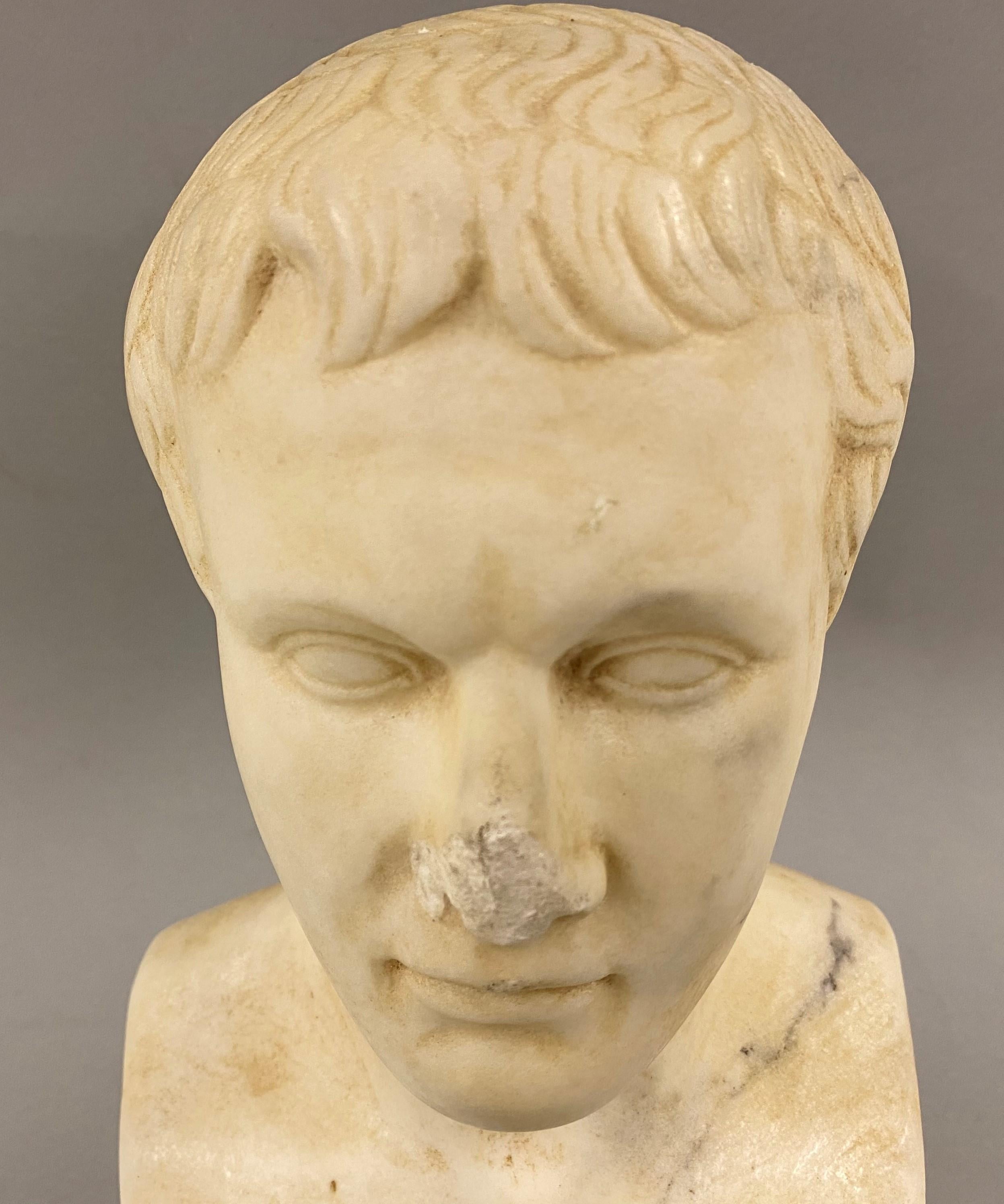 A fine example of a hand carved marble bust of Augustus Caesar with concretions and other evidence of long-term burial suggesting its origin as ancient Rome, probably dating to the second century AD. The bust is unsigned, in very good condition,