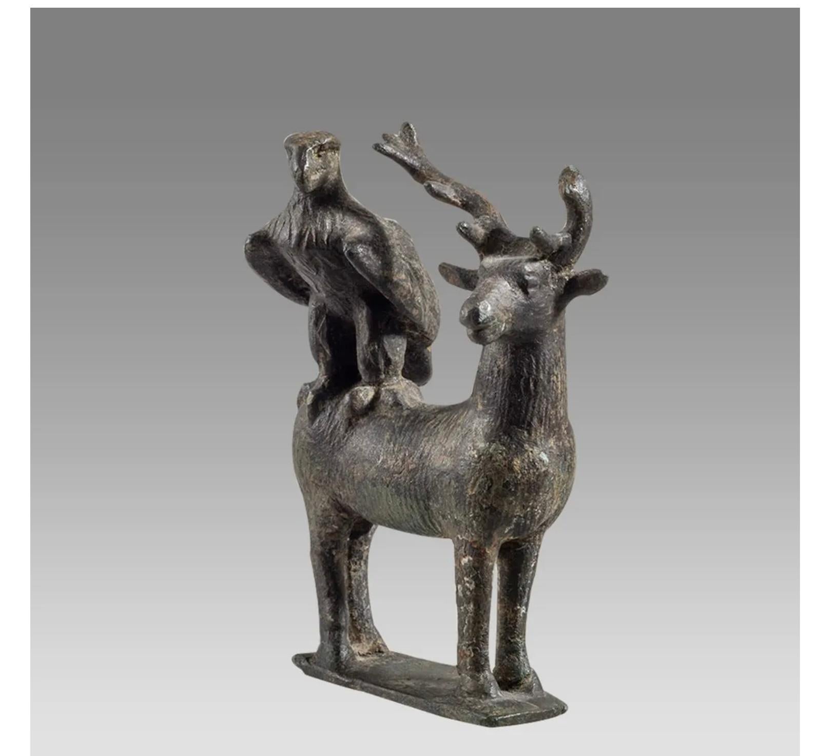 This Ancient Roman Military Bronze eagle and stag, dating from the 1st to 2nd century AD, stands at a modest yet captivating 3 1/8 inches in height. The finely cast bronze sculpture showcases an eagle alongside a stag, symbolizing the divine