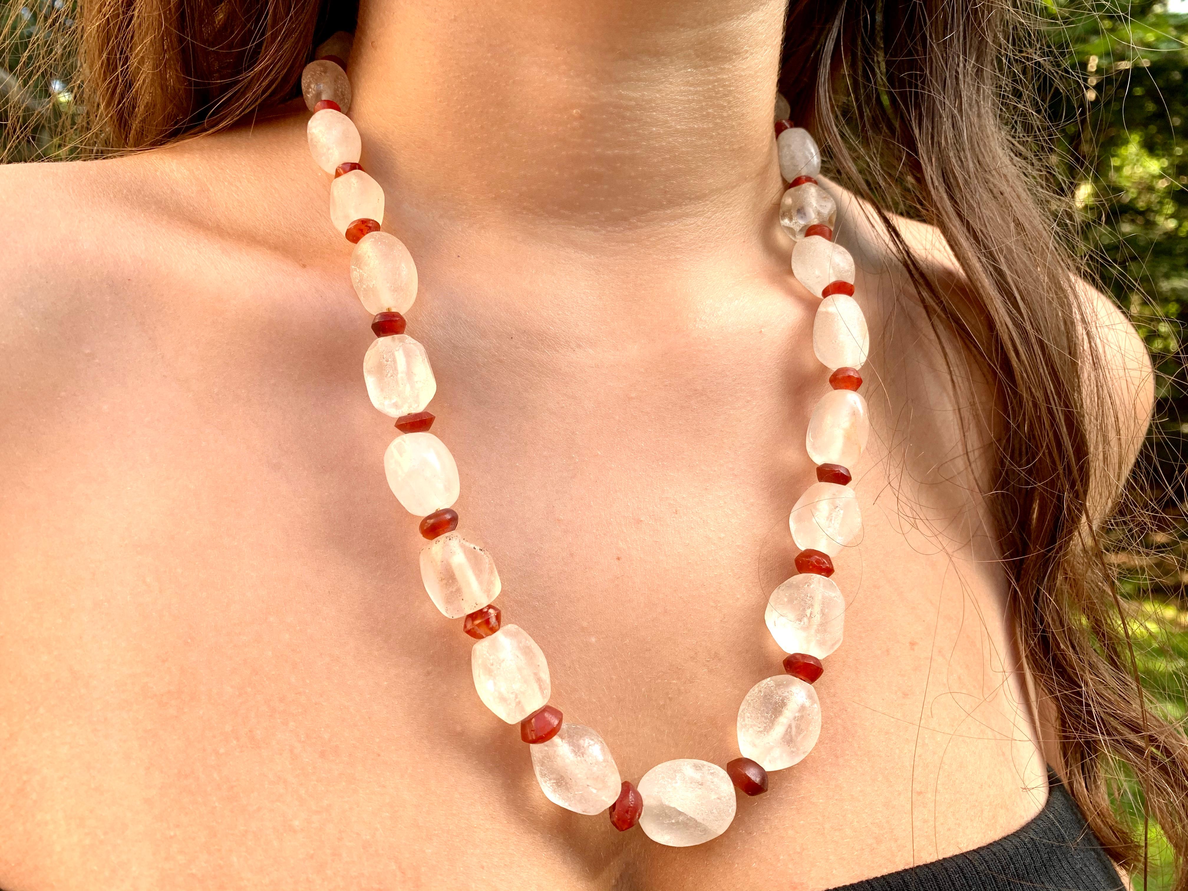 Rare large scale ancient Roman rock crystal and carnelian bead necklace, approximately 2000 years old, composed of twenty five elongated oval rock crystal beads, interspersed with twenty six spherical carnelian beads, graduated in size with rock