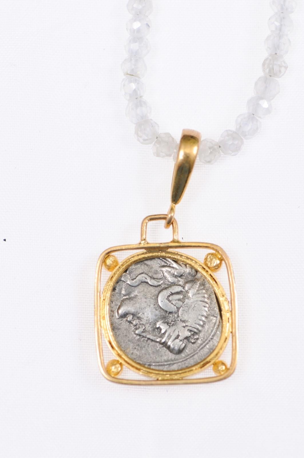 Une authentique pièce de Denier en argent de Q. Titius (Rome, vers 90 av. J.-C.), sertie dans un chaton en or 22k personnalisé, suspendue dans un chaton carré avec des accents de perles d'or à chaque coin, et une anse en or 22k. L'avers de cette