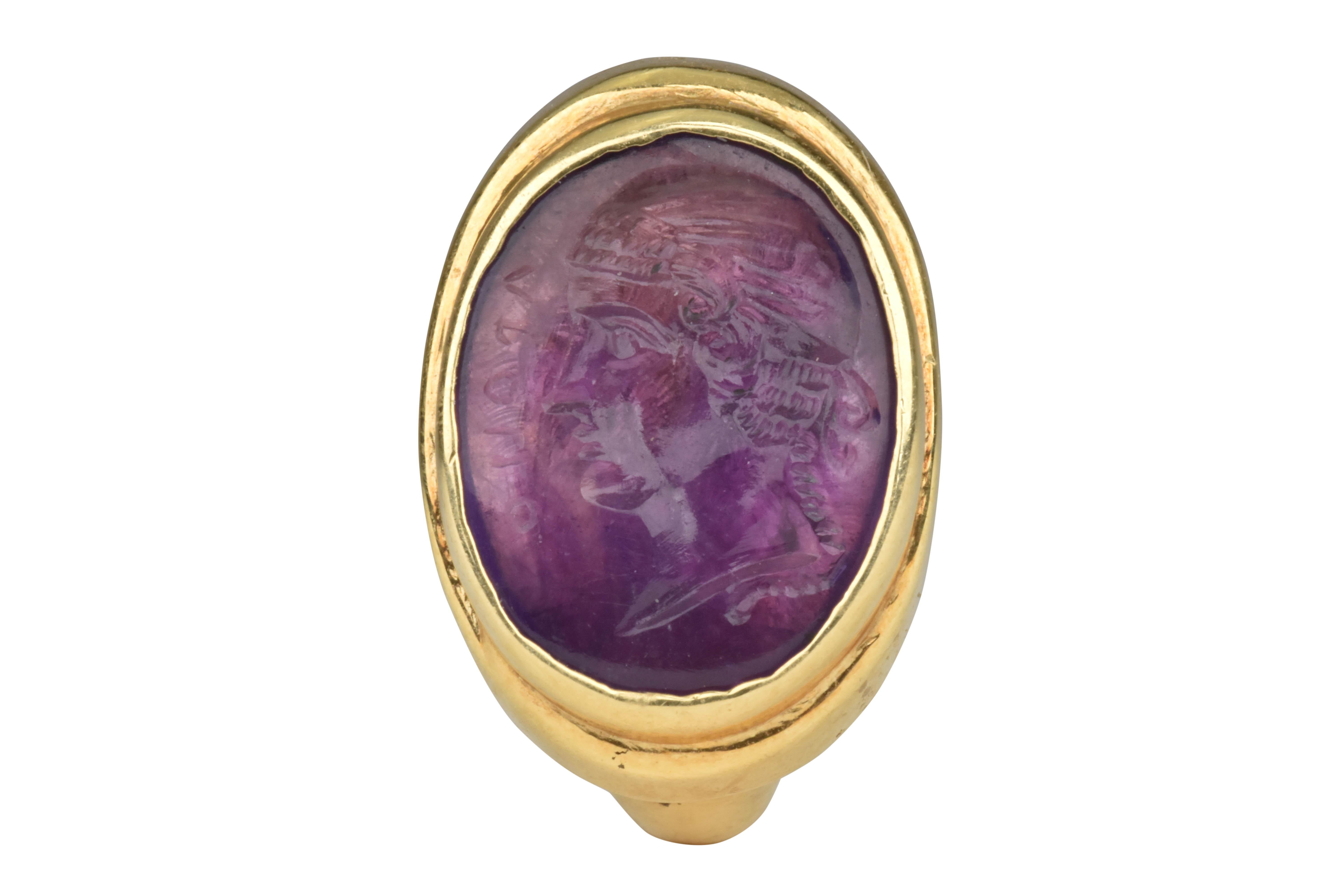Ancient Roman Portrait Amethyst Intaglio in a Neo-Classical Gold Signet Ring

Ca. 100 AD (Stone), Ca. 1900 AD (Ring), An Ancient Roman amethyst intaglio featuring the depiction of a female bust seen in a left profile. The figure is portrayed with a