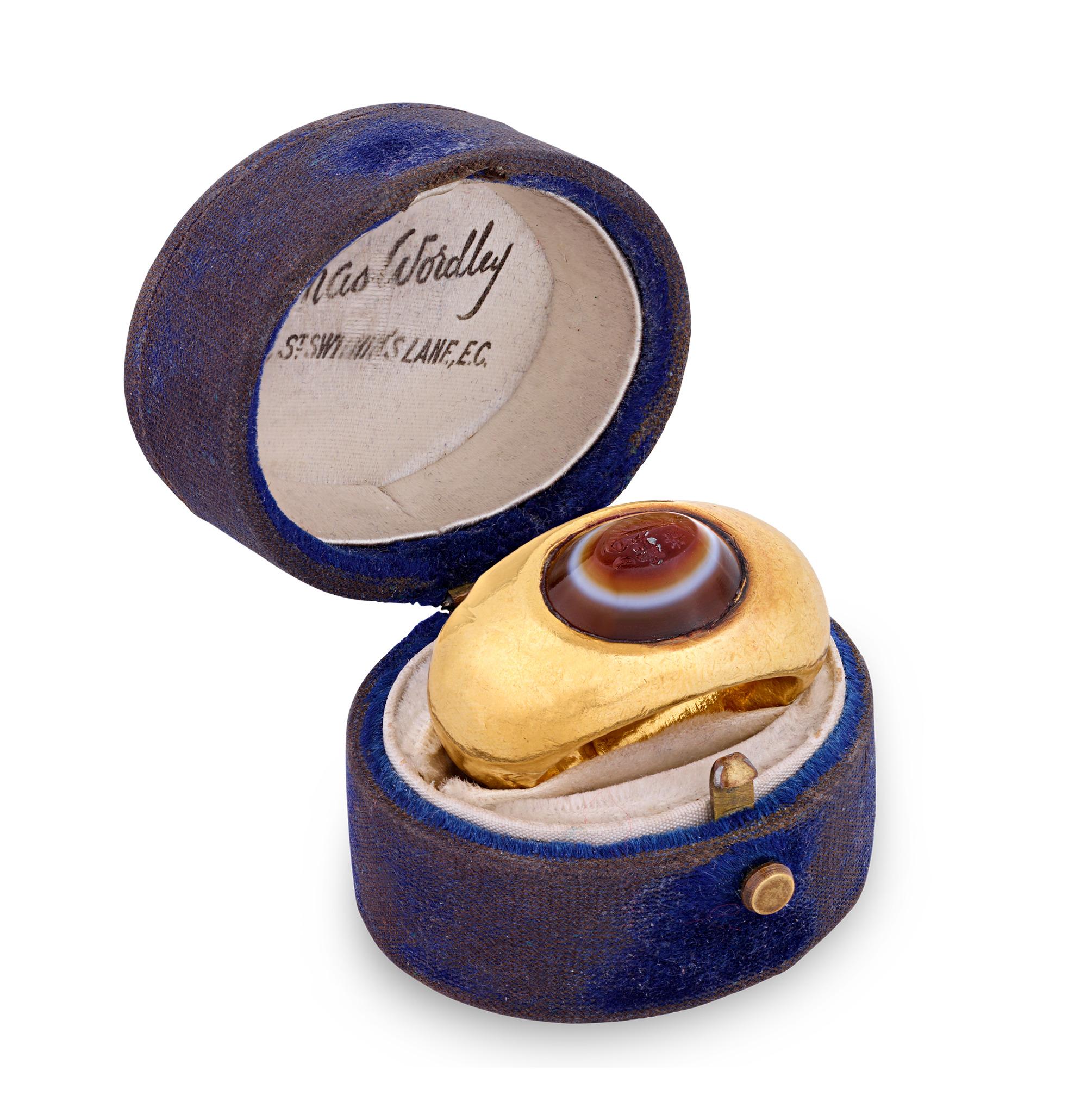 Exceptionally rare and crafted in the 1st or 2nd century CE, this banded agate Roman intaglio ring hails from the Roman Empire. Displaying the rich red color and carved with the image of Neptune, the Roman deity, the create exudes the glory of late