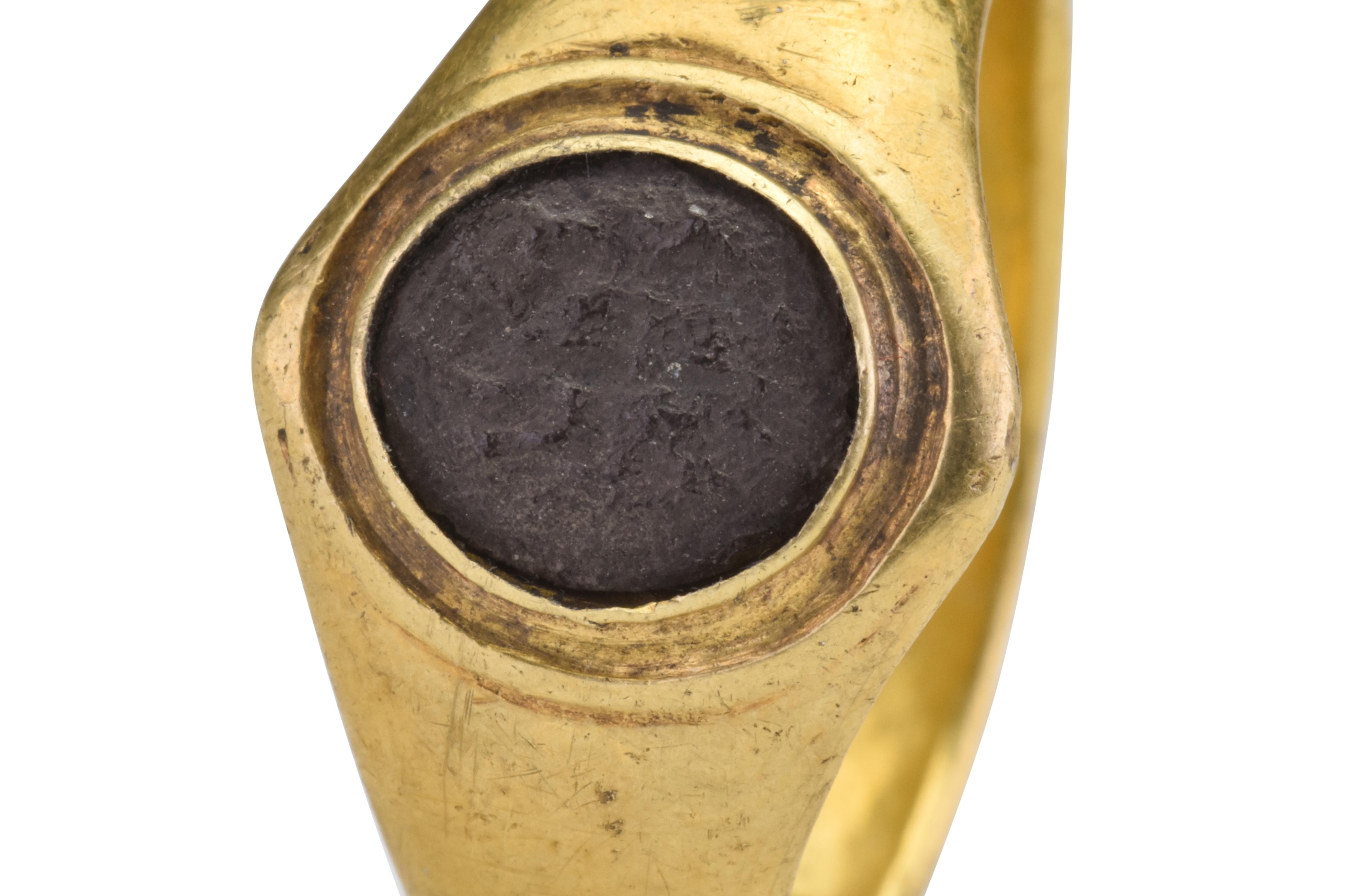 Ancient Roman Signet Gold Ring with Silver Center 

Ancient Roman, Ca. 200-300 AD

A high karat yellow gold ring centered with an oval silver inset with a design in relief.

Provenance: Private London collection; Previously with I.G.; acquired from