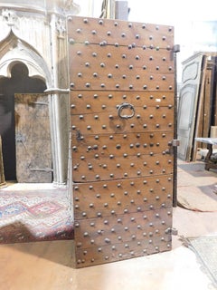 Old Rustic entrance door in walnut with nails, from northern Italy
