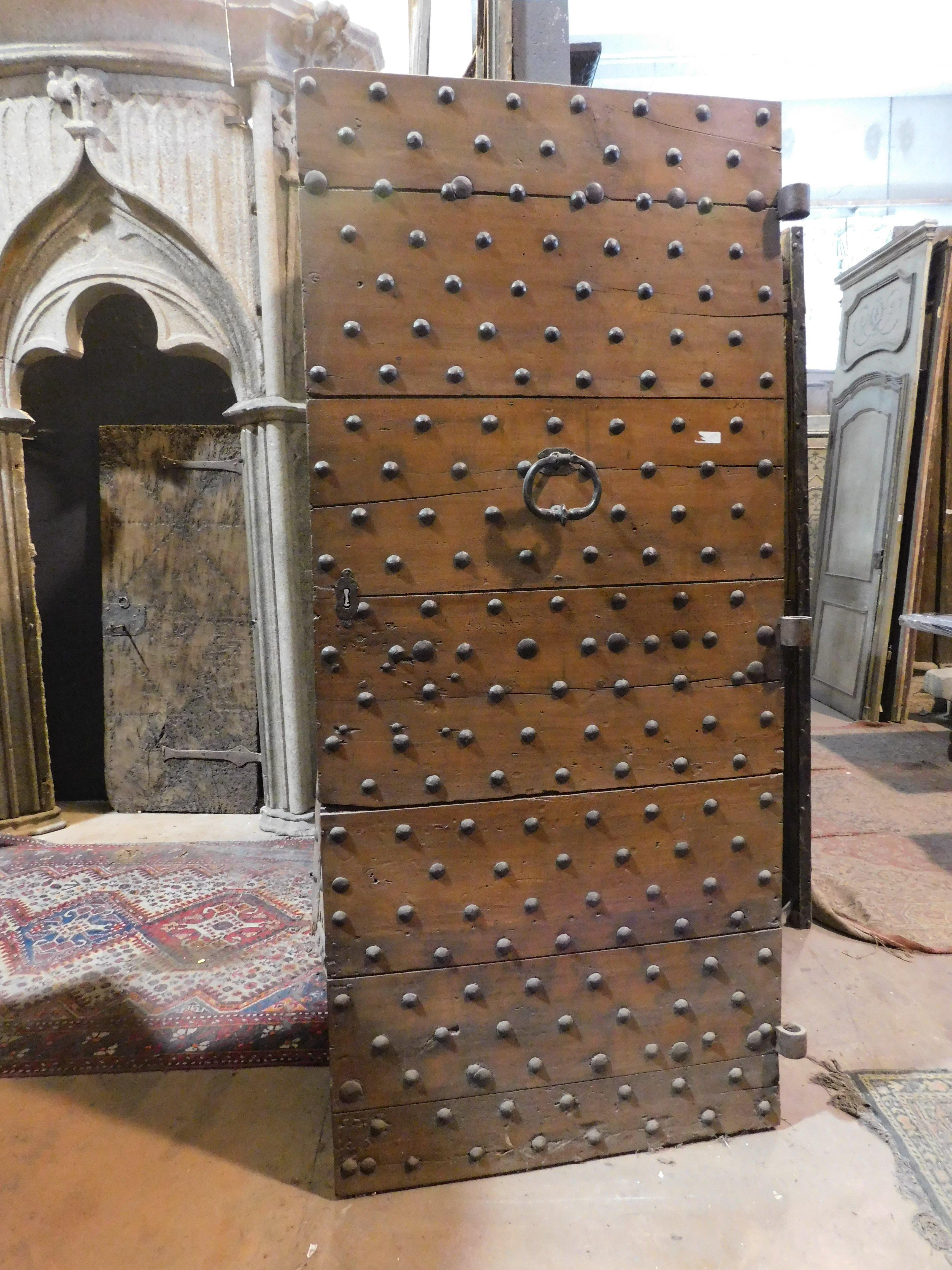 Italian Old Rustic entrance door in walnut with nails, from northern Italy For Sale