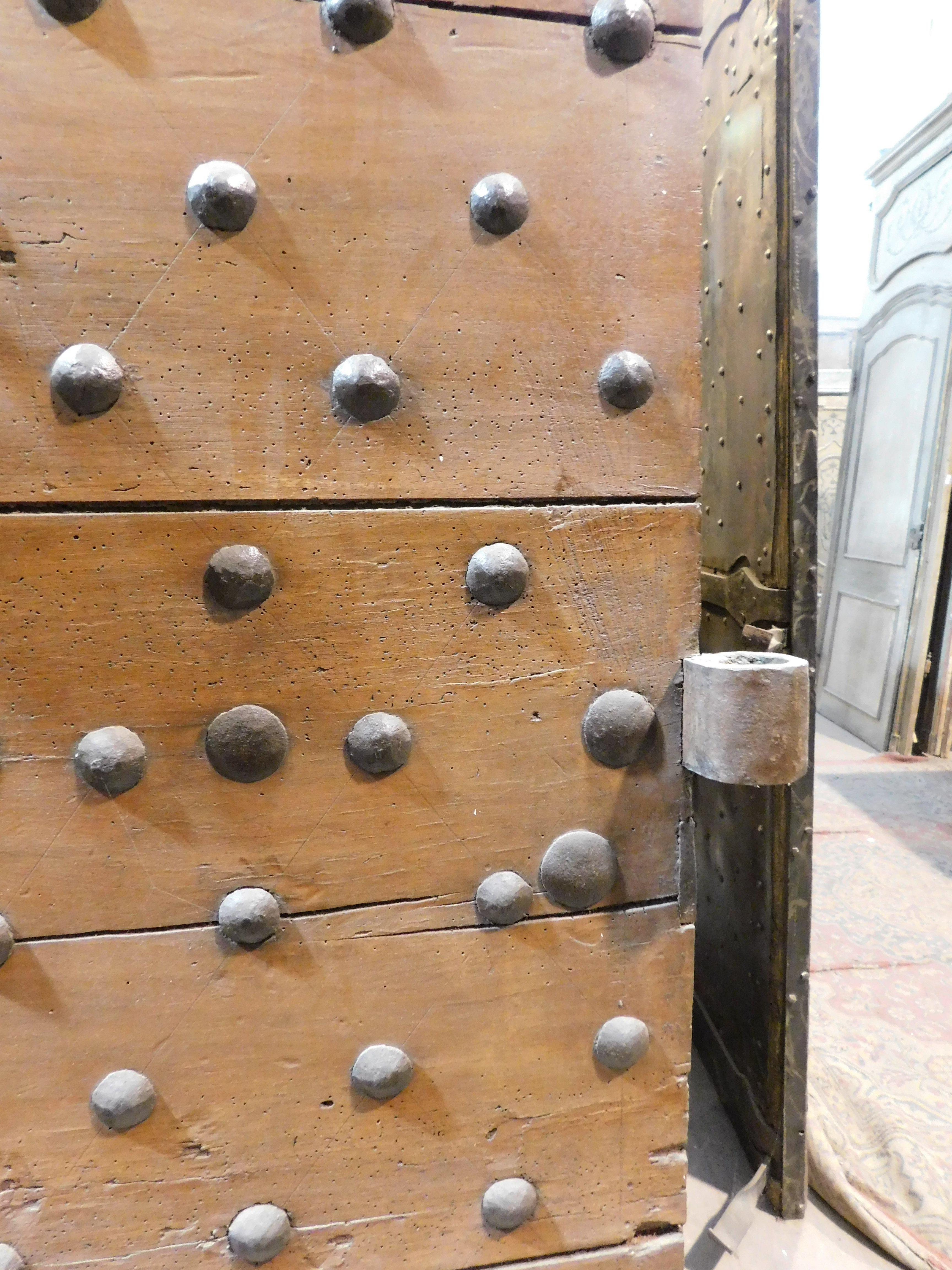 18th Century and Earlier Old Rustic entrance door in walnut with nails, from northern Italy For Sale