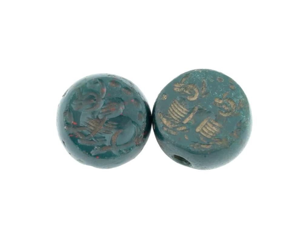 A lot of two ancient Sasanian hand carved bloodstone intaglio beads. Intaglio is adorned with animal compositions. Ancient and Antique Sasanian Historical Collectibles, Intaglios And Seals.

Dimensions: D 1/2 in. All measurements are