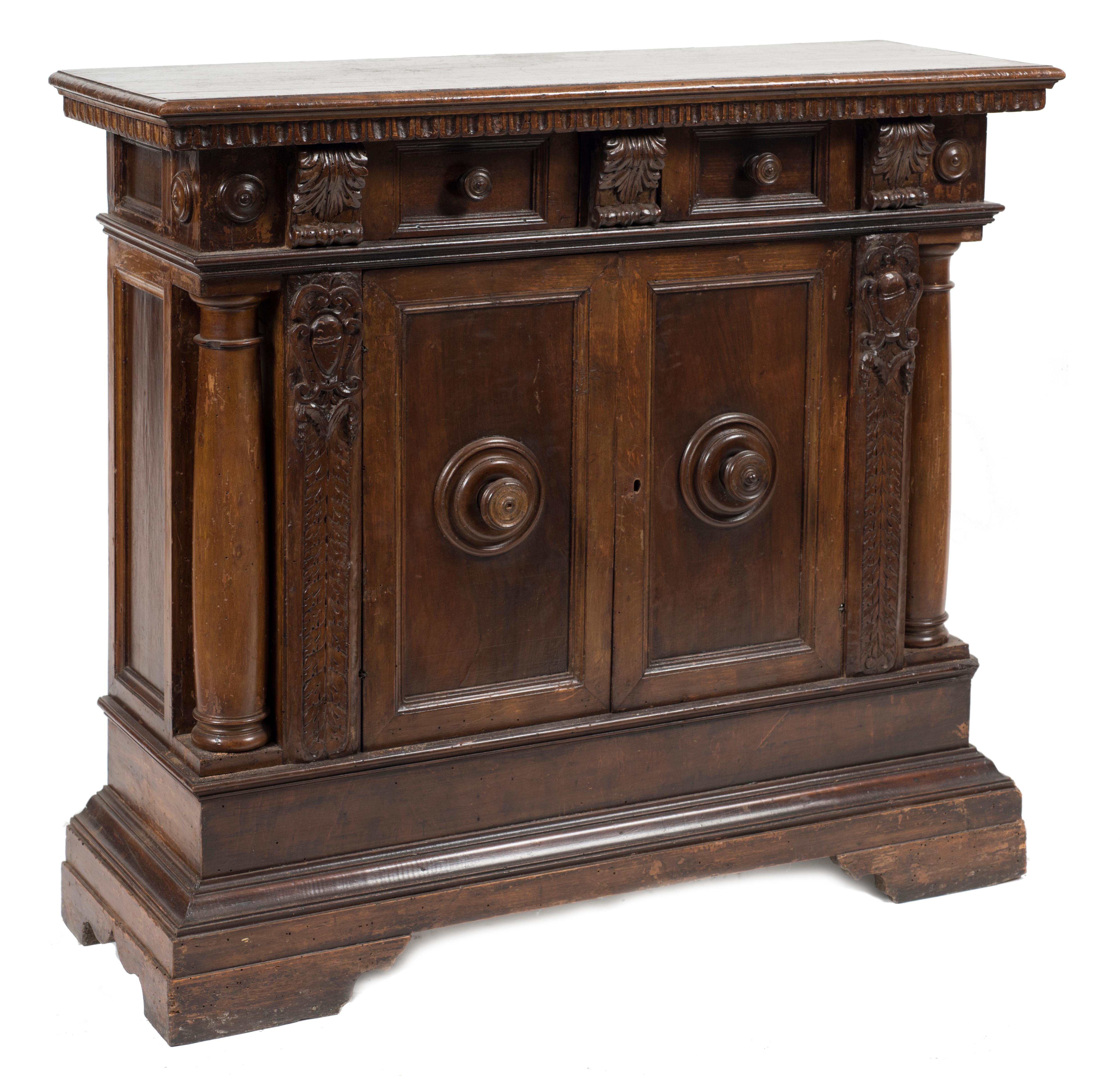 Ancient sideboard in walnut Renaissance style, top with 2 drawers and bottom with 2 doors and 3 internal shelves. On both sides two embossed columns which bear the top table, Italy, end of the 19th century.

This object is shipped from Italy.