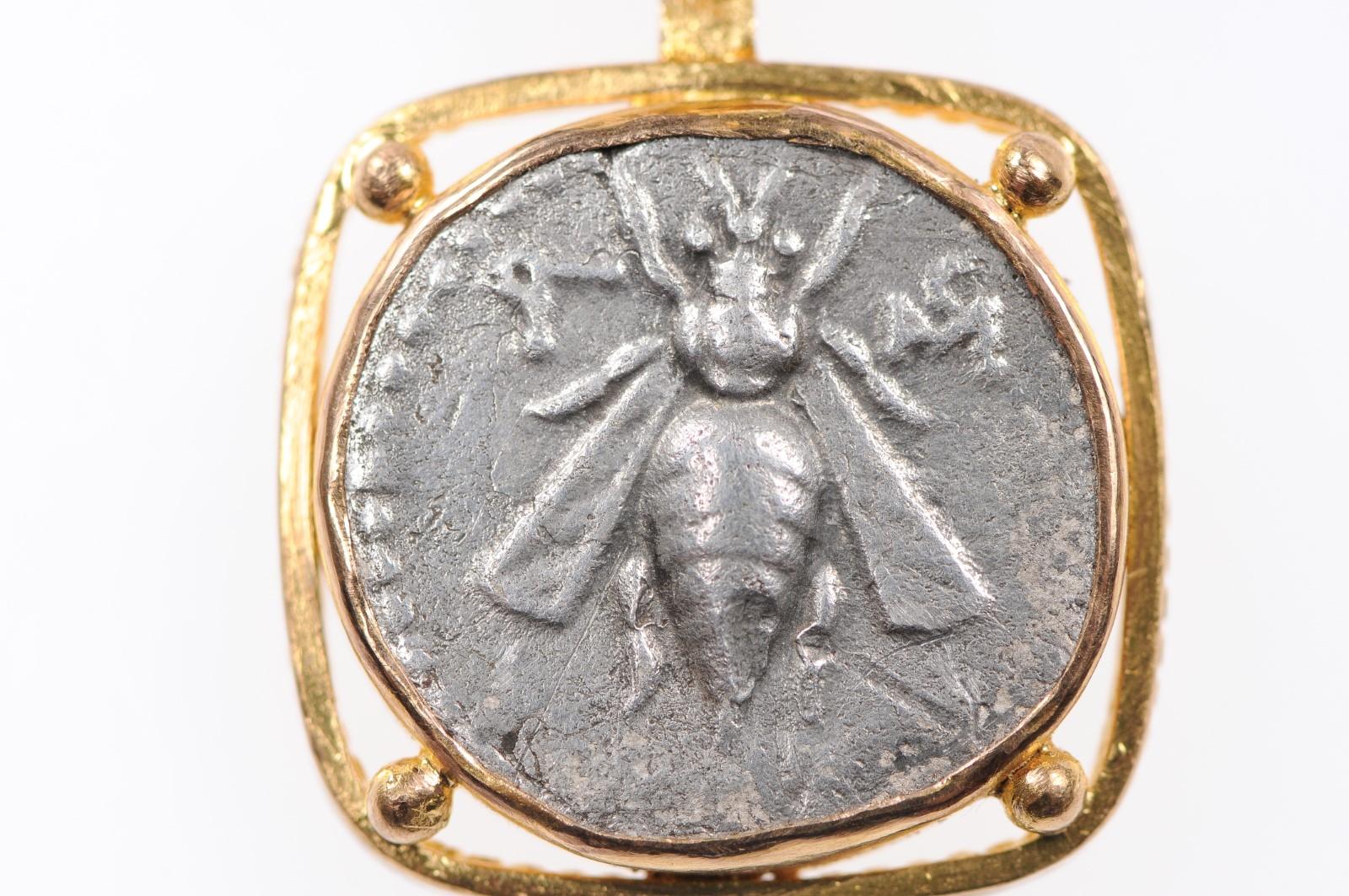 An authentic ancient silver AR Drachm Bee/Stag coin (circa 197-180 BC), Ephesus or Ephesos, on the Aegean Sea in Ionia; present day Efes, Turkey. This ancient Greek coin has been floated with a squared 22-karat gold bezel with roped accents about