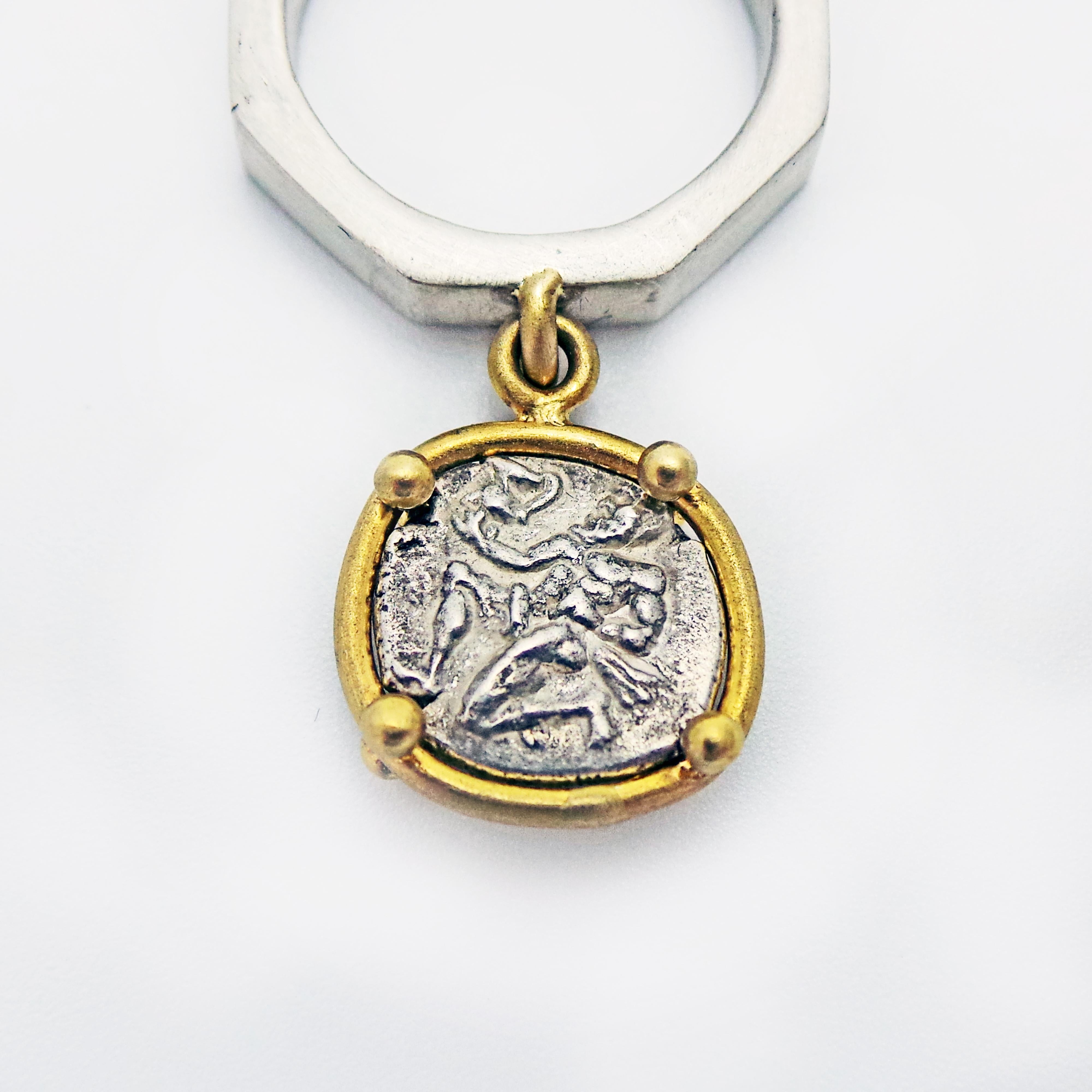 Ancient Greek silver coin of Rhodes set in 22k yellow gold, and fixed on a sterling silver octagon shaped ring.  Size 6 1/2. Both beautiful sides of this ancient Greek coin may be featured, depending on which way you choose to wear this flip charm