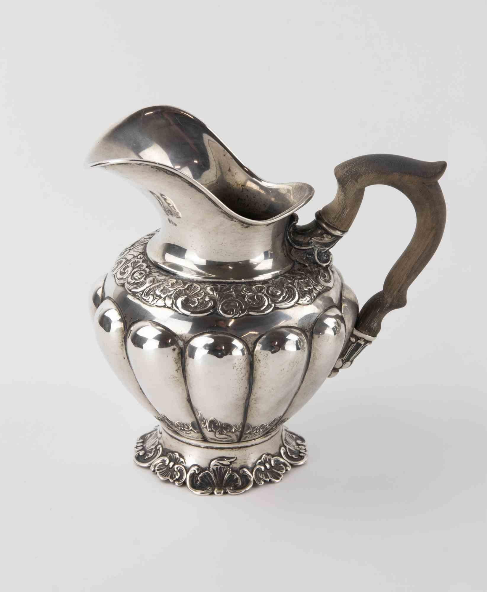 19th century silver 800 set comprising a coffee pot, a tea pot, water or milk Jug and a sugar bowl.

Ebonized wood handles.

Very good condition.