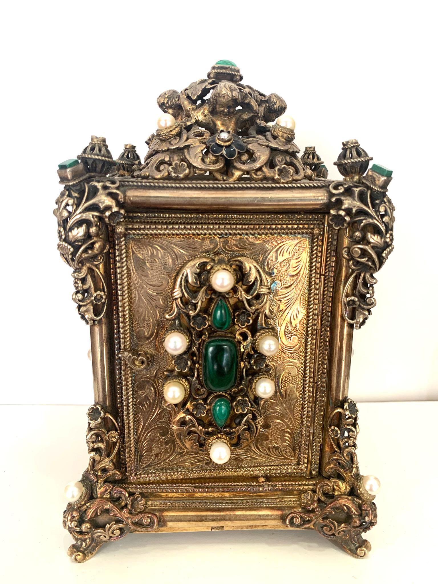 Ancient Table Clock

Beautifully designed clock from the 30's. 
Made of silver with pearls and valuable green stones.

