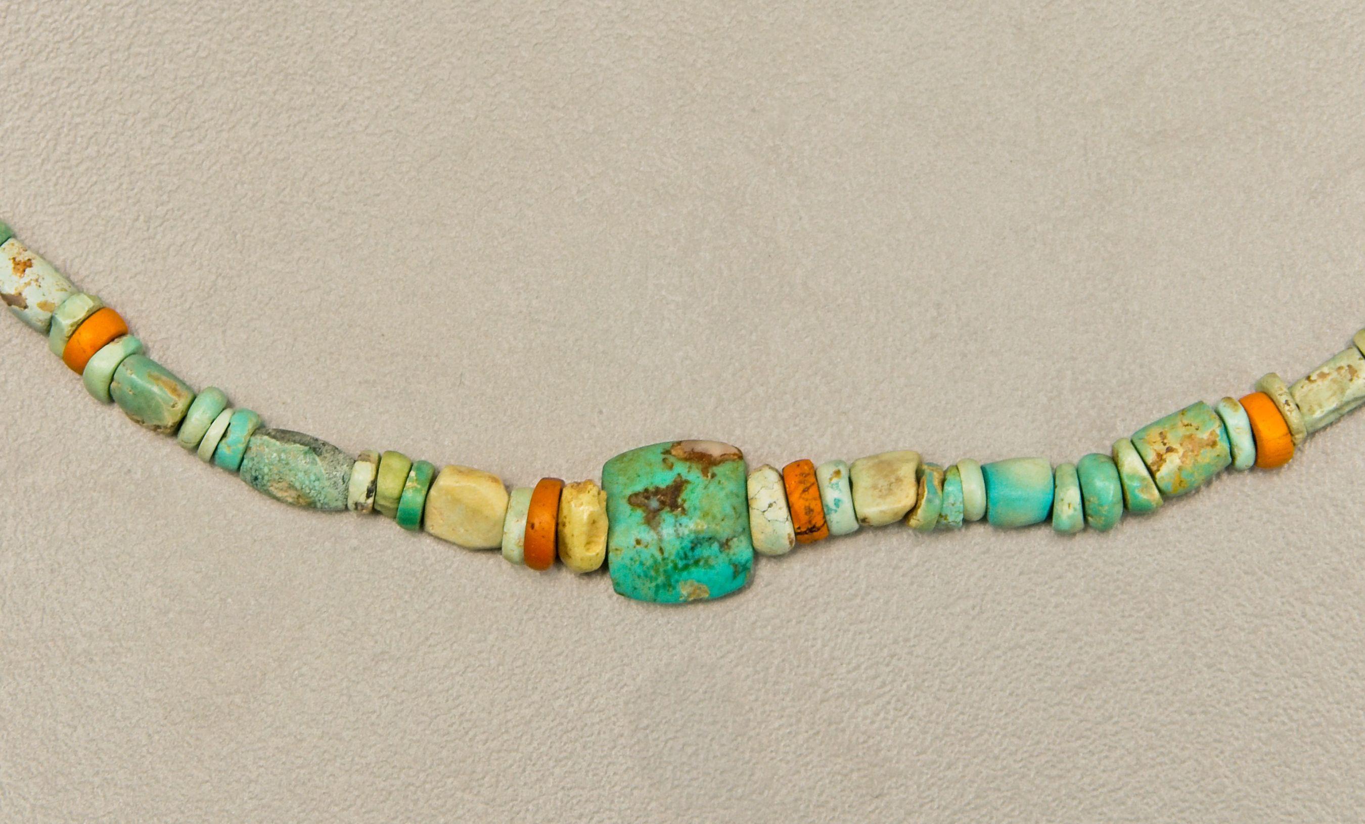 Two hundred twenty-seven ancient turquoise beads with twenty orange colored ancient glass disc beads evenly spaced throughout the necklace. There are one hundred sixty-six very small turquoise disc beads and sixty tube or flattened tube beads. At