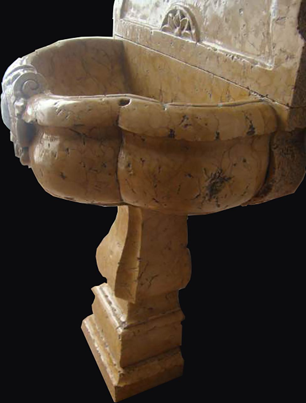 Ancient wall fountain in yellow Siena marble finely sculpted and decorated with rosettes and shells with red Verona marble settings.

Central Italy, early 18th century

healthy and in perfect general conditions, only normal imperfections due to