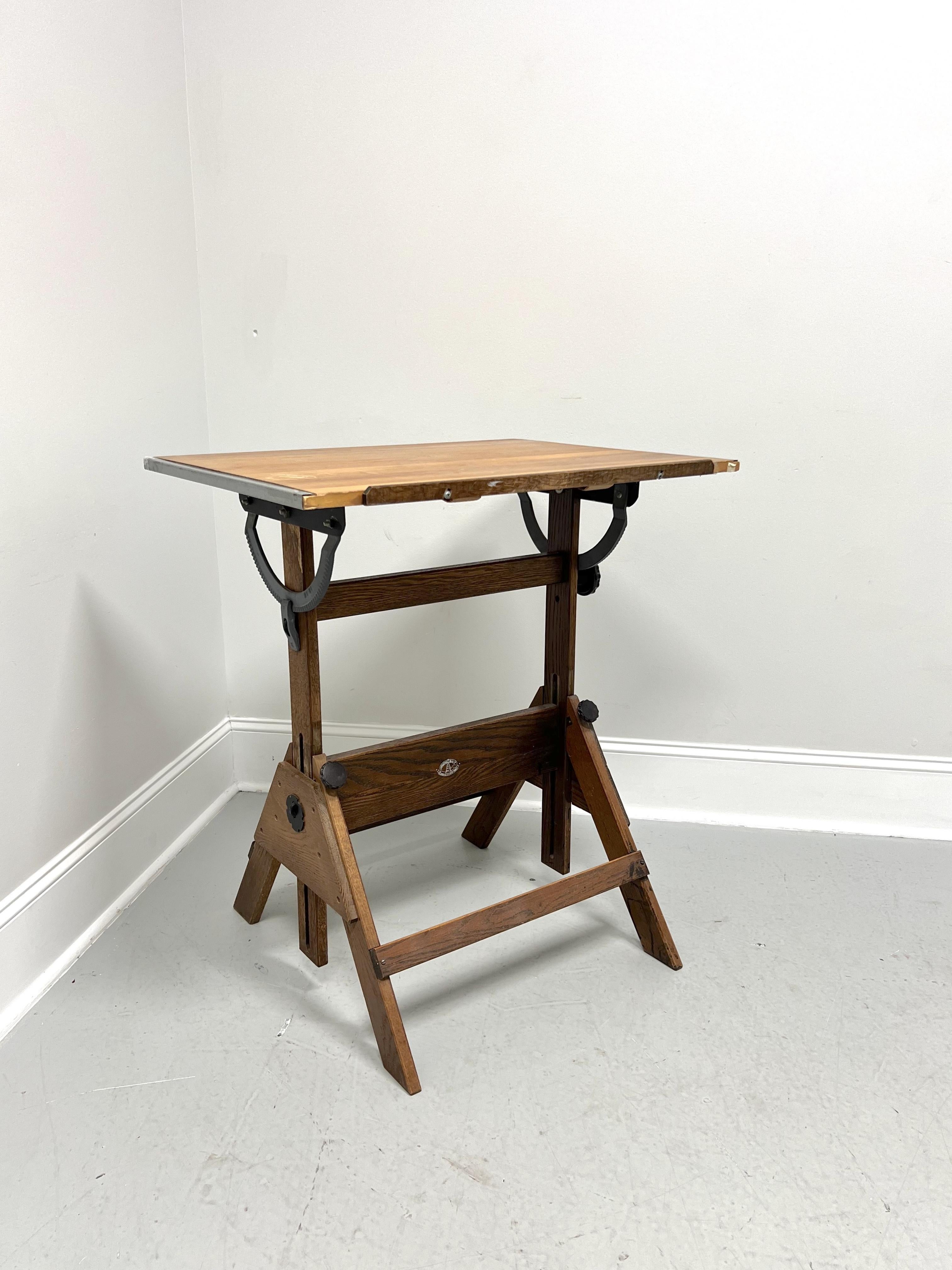 A Mid 20 Century MCM drafting table by Anco Bilt. Oak & pine woods, metal mechanisms, adjustable tilt-top, adjustable height, and 