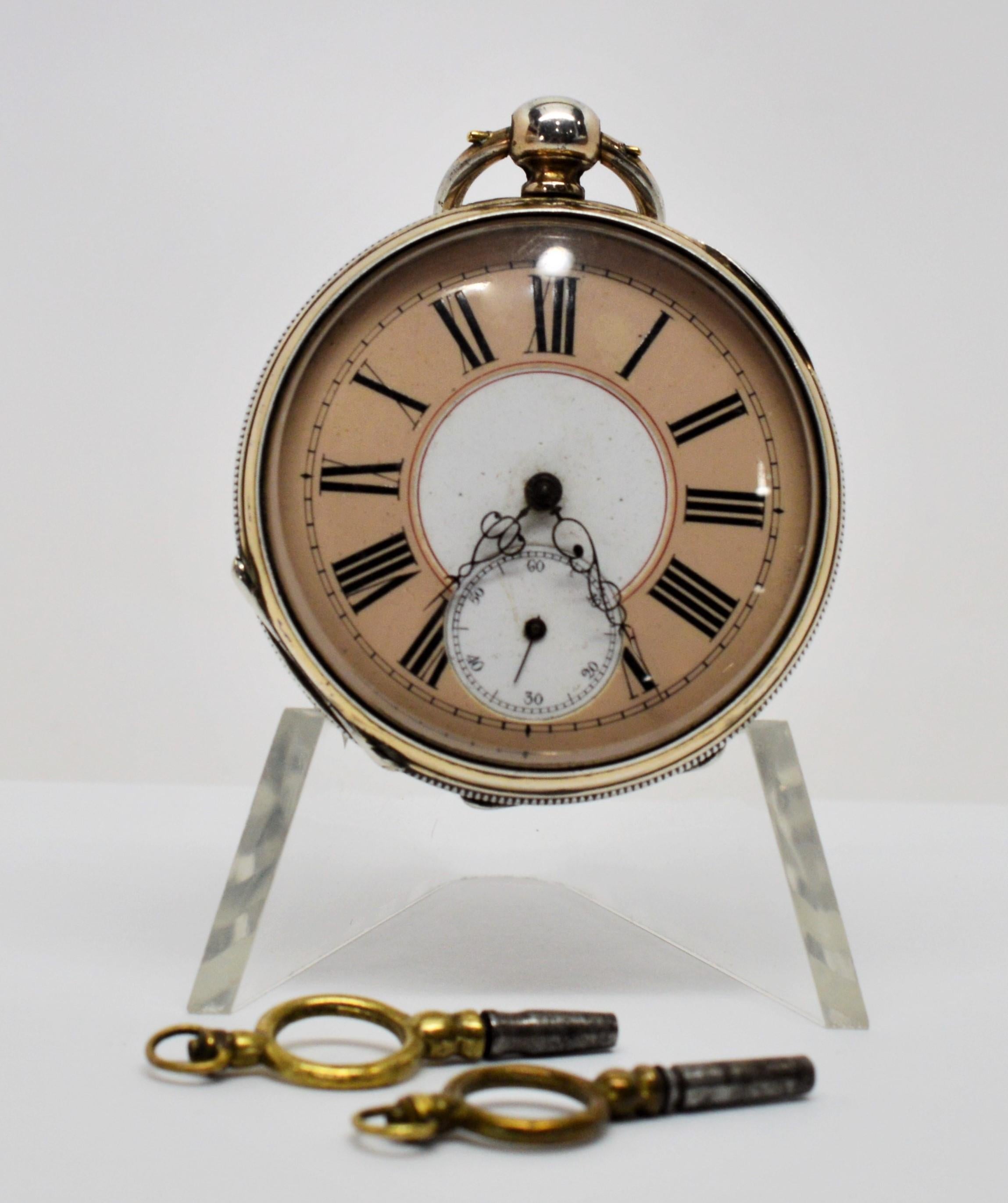 In superb original condition, circa 1880,  Ancre DePrecision sterling silver 48mm pocket watch with fourteen karat 14K yellow gold trim. Back is engraved with scroll medallion design. Two color face with Roman numerals. Case by JSLT 78021. Swiss key