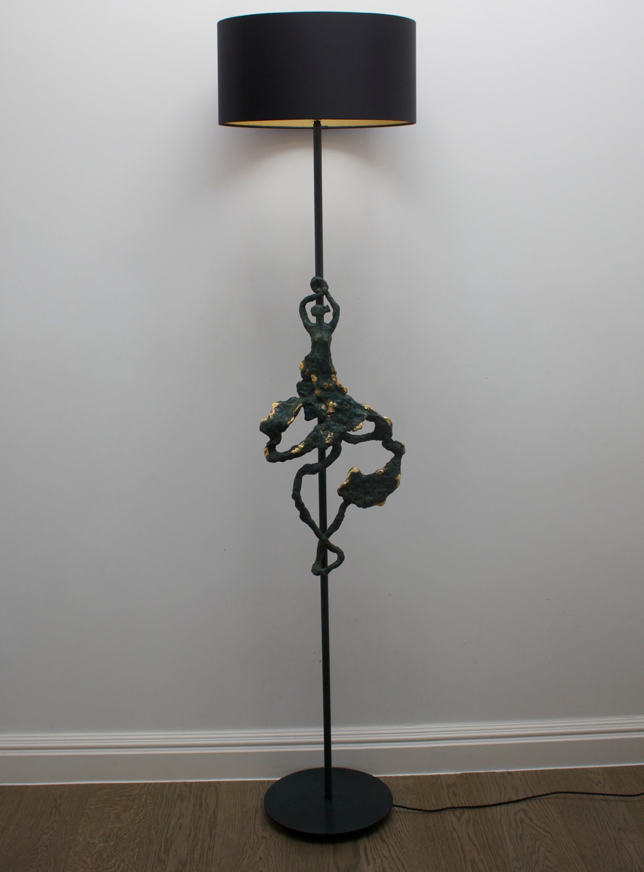 Titled 'Flamenco', this exquisite  sculptural bronze floor lamp is meticulously handcrafted to embody the essence of Flamenco dance.  Inspired by the artist and designer's Spanish heritage, the lamp captures the graceful movements and vibrant energy