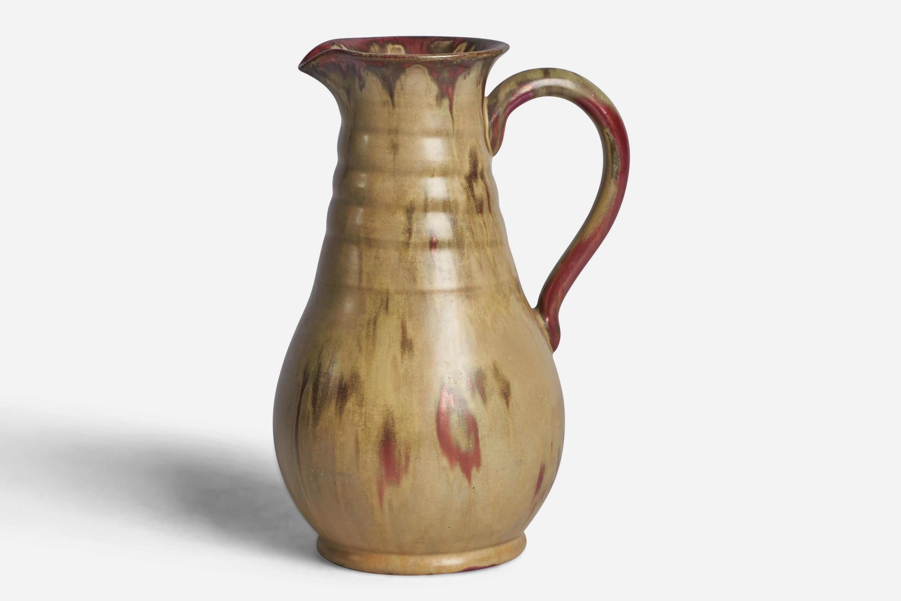 A beige-glazed stoneware pitcher designed and produced by Andersson & Johansson, Höganäs, Sweden, 1940s.