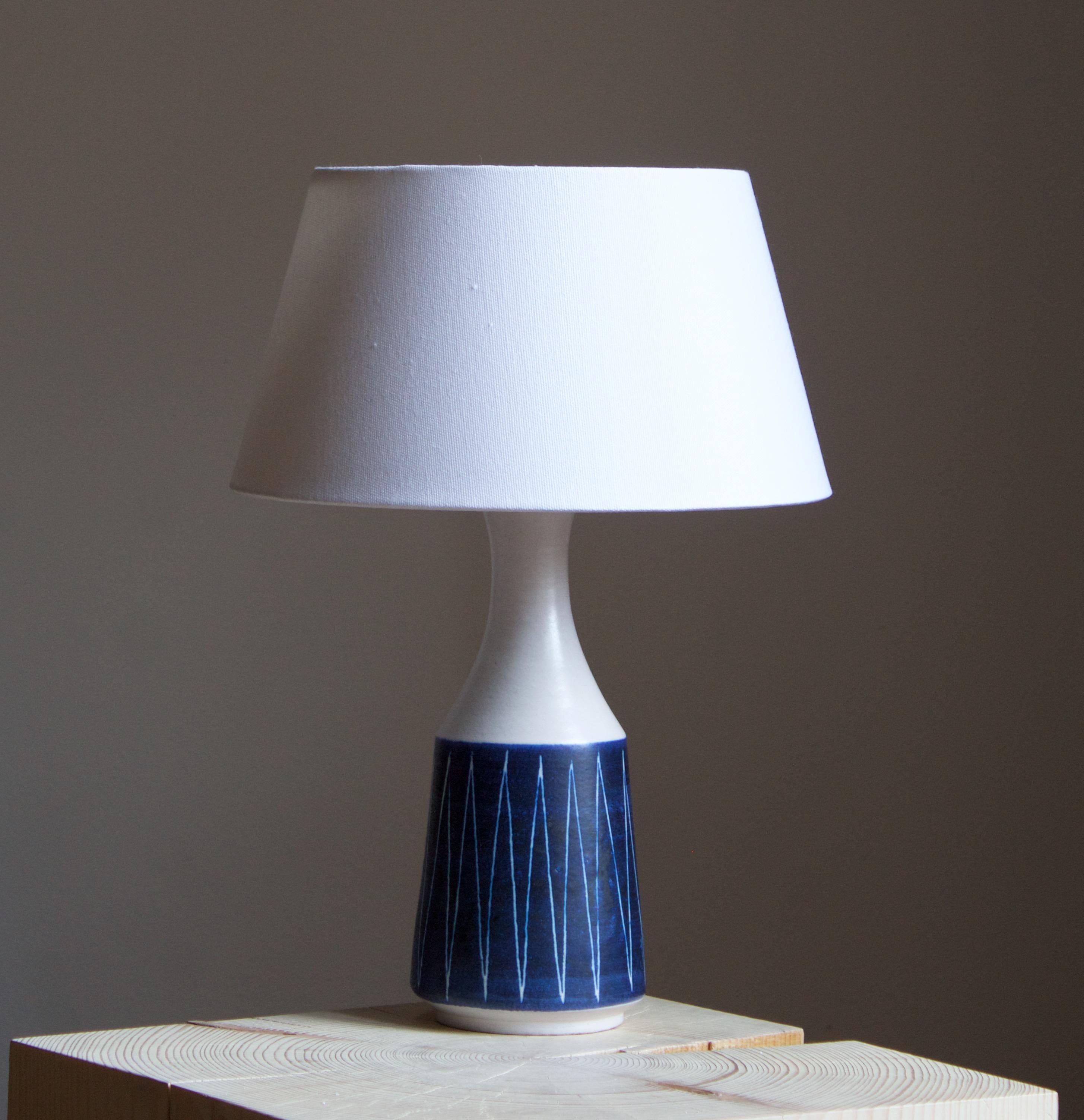 A table lamp, produced by Andersson Johansson, Höganäs, Sweden, c. 1940s. Stoneware

Features simple hand-painted decor.

Stated dimensions exclude lampshade. Height includes socket. Sold without lampshade.

