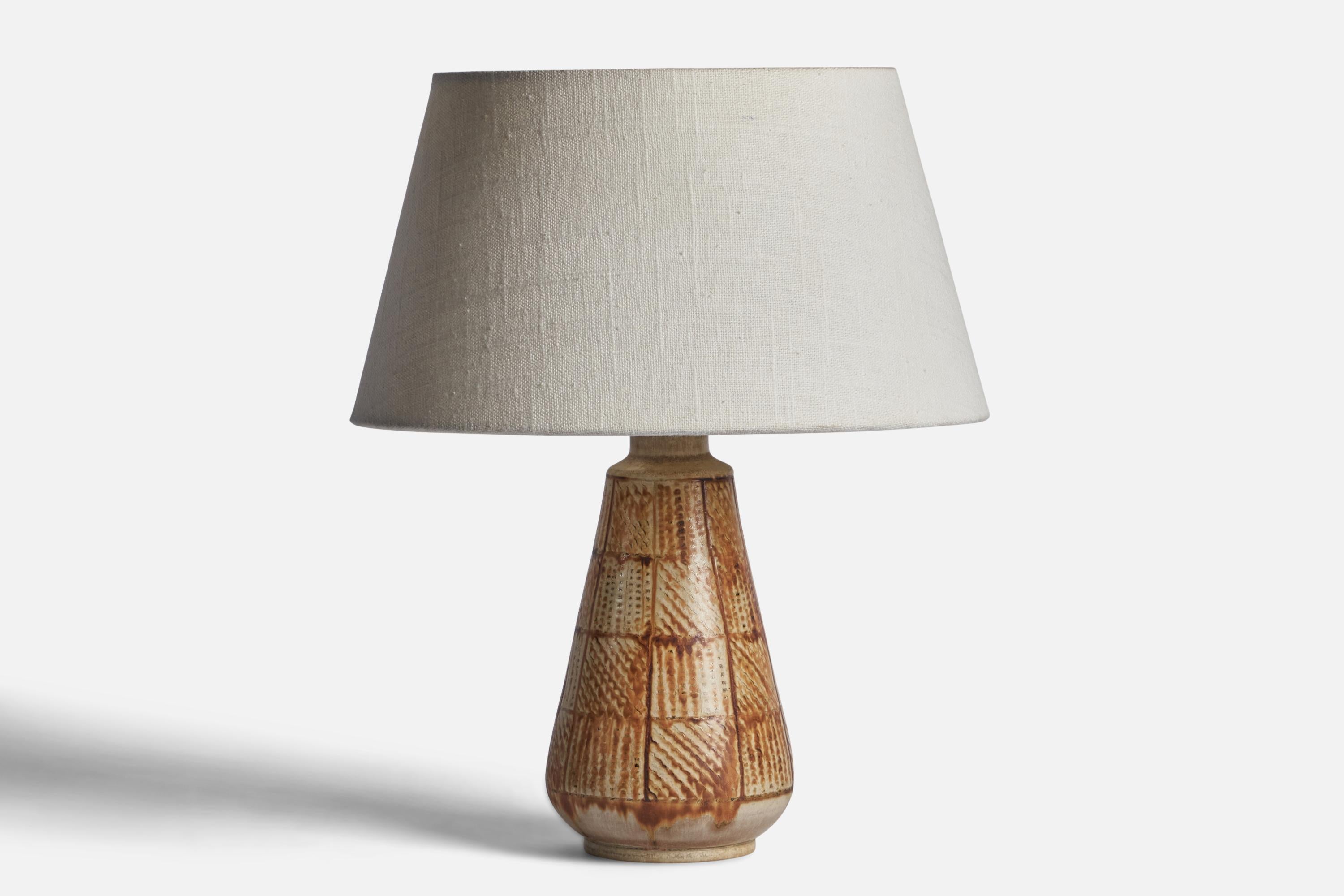 
A brown and beige-glazed stoneware table lamp designed and produced by Andersson & Johansson, Höganäs, Sweden, c. 1950s
Dimensions of Lamp (inches): 9.25” H x 3.95” Diameter
Dimensions of Shade (inches): 7” Top Diameter x 10” Bottom Diameter x 5.5”
