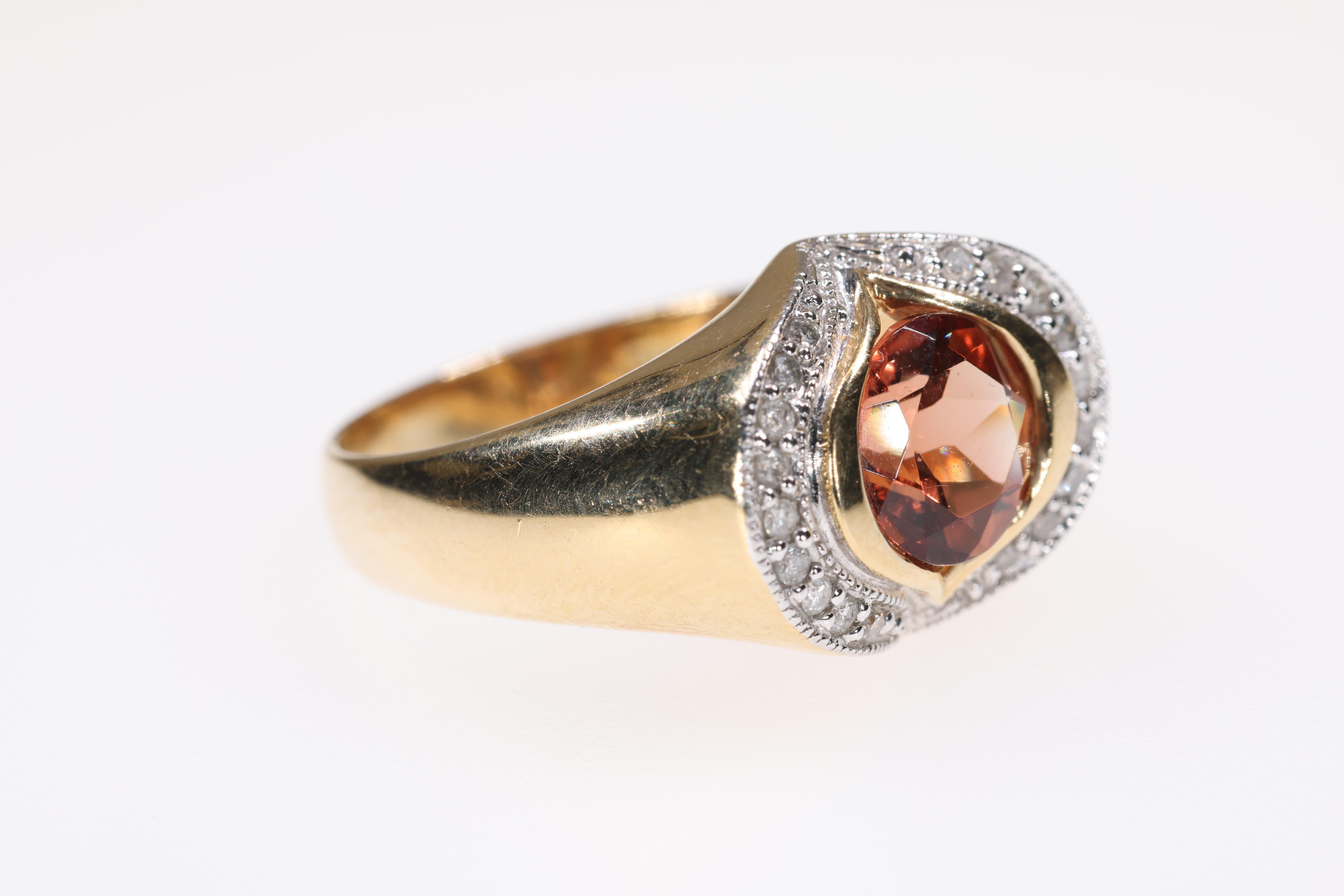 This is a beautiful fashion ring that has an Andesine Feldspar center stone of deep rich color. The ring is made from 14K yellow and white gold and has 20 accent diamonds.