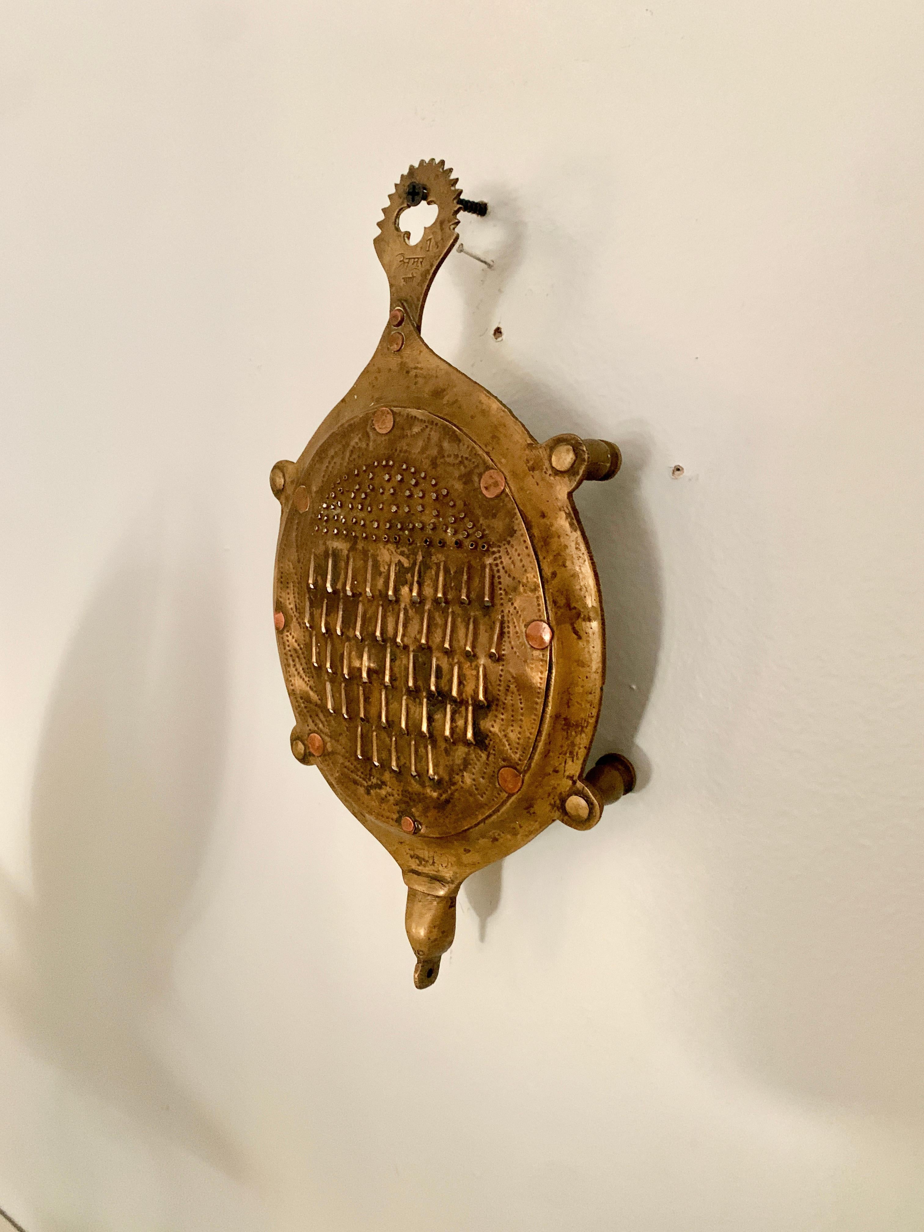 Andhra Pradesh solid brass cheese or vegetable grater in the shape of a turtle. Andhra Pradesh, in particular, has a history of outstanding metal workmanship or “Vishwakarmas”, which can be traced back to the grandeur and glory of the Kakatiya