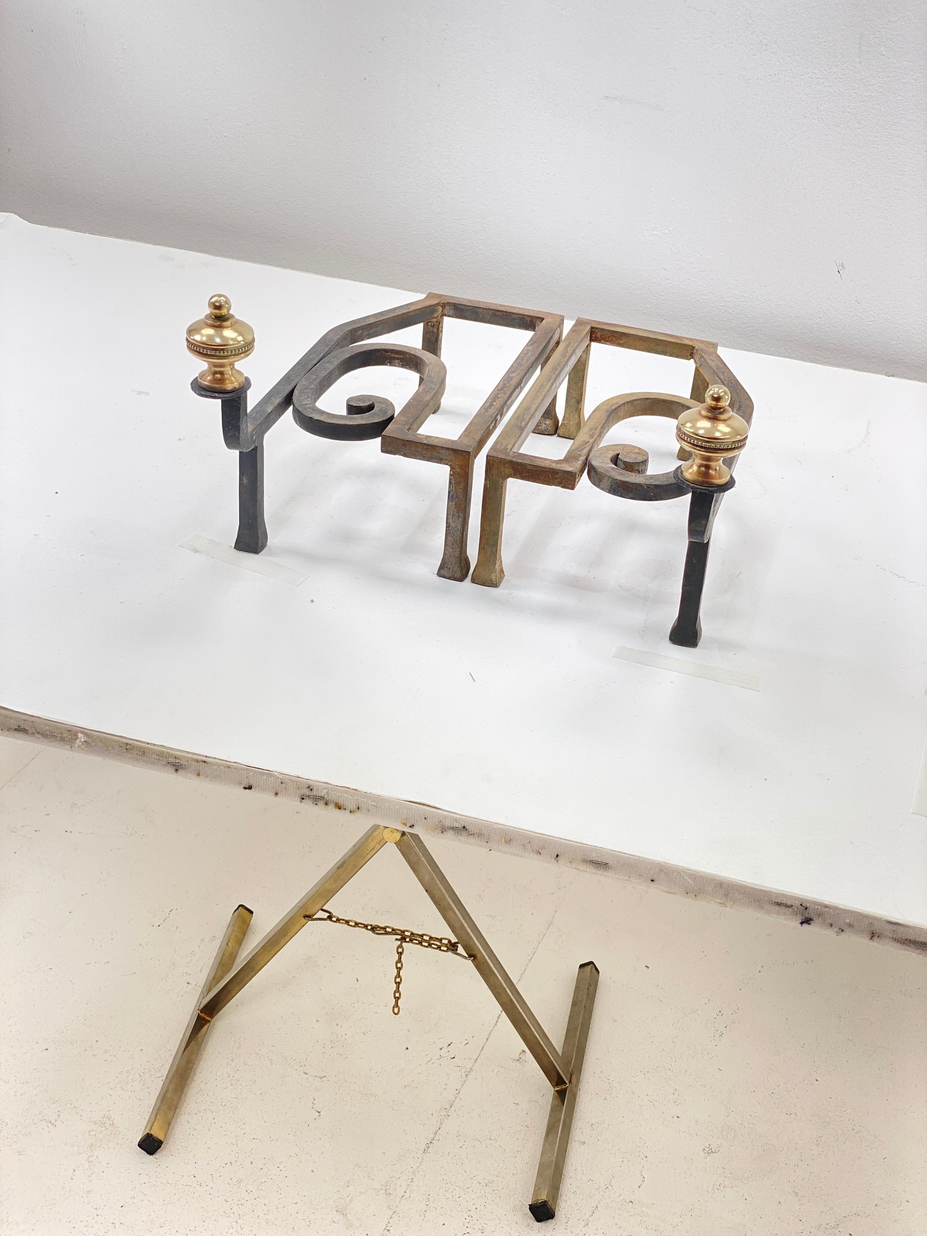 This pair of andiron are in Iron and brass. They have been made in France, Circa 1960.