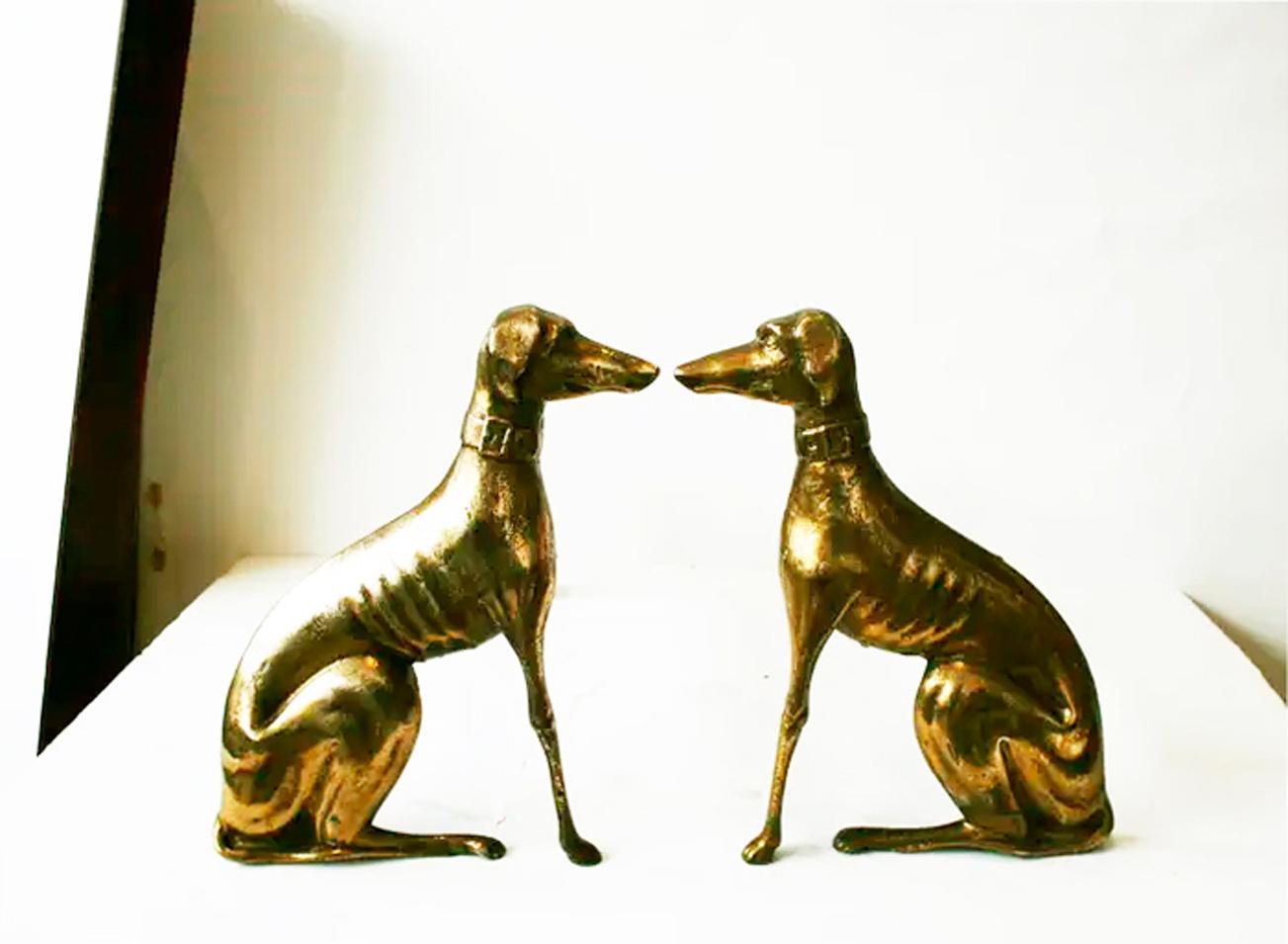 A pair of  brass greyhound dog andirons from  the 20th century. This pair of brass andirons features two greyhounds facing each other. Their facial expressions along with the details of their bodies are skillfully represented. 

The animals are