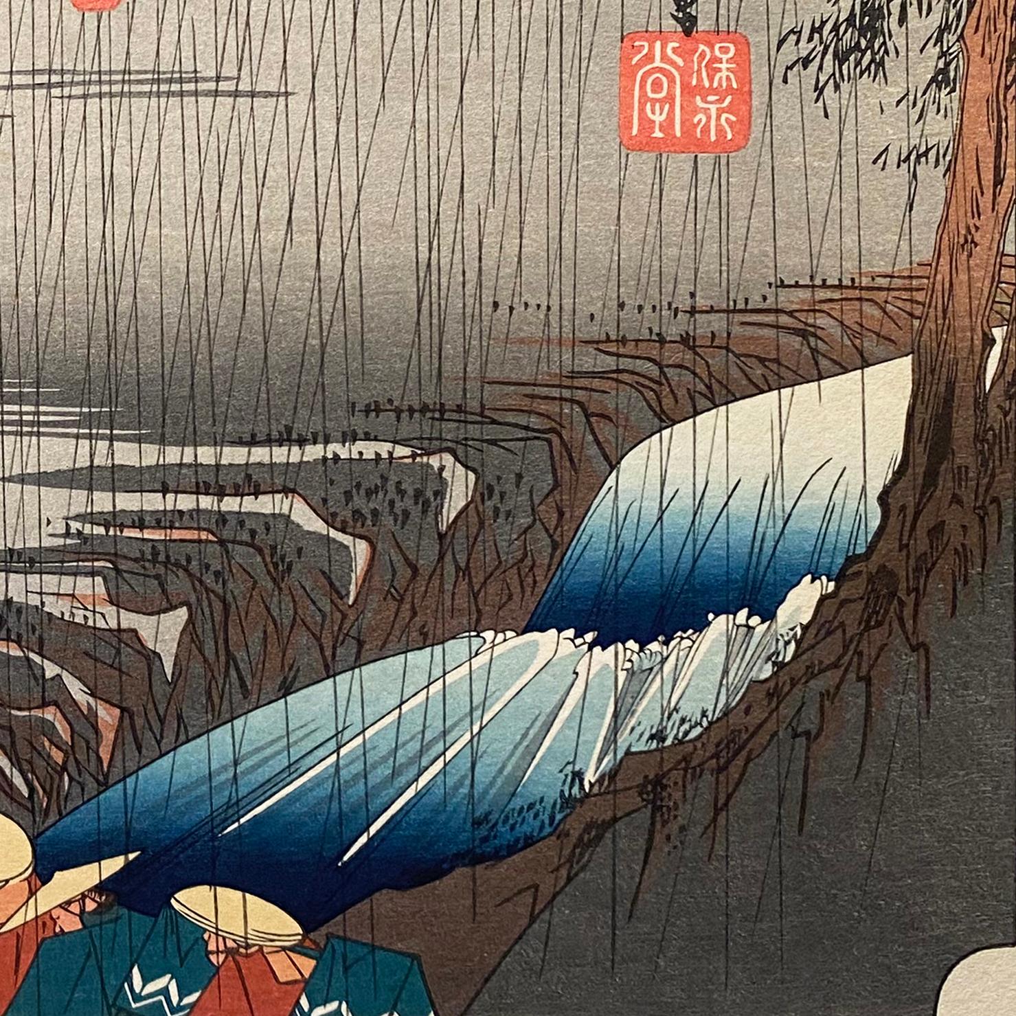An ink on paper, Nishiki-e and Yoko-e woodblock landscape showing a daiymo procession caught in the rain. Signed in Kanji lower left, 
