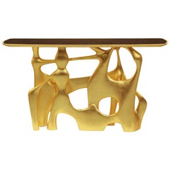 Table console Andore en finition dorée avec plateau en noyer