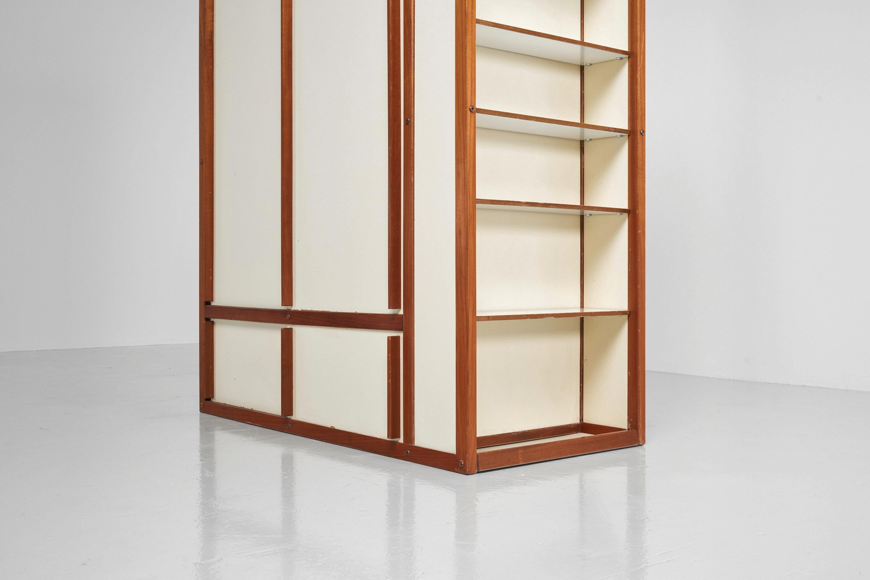 Stunning minimalistic room divider wardrobe designed by cabinet maker Andre Sornay, France 1955. This rare room divider cabinet was designed with his 'tigette system' which was basically a modular formula which he used to make many furniture in