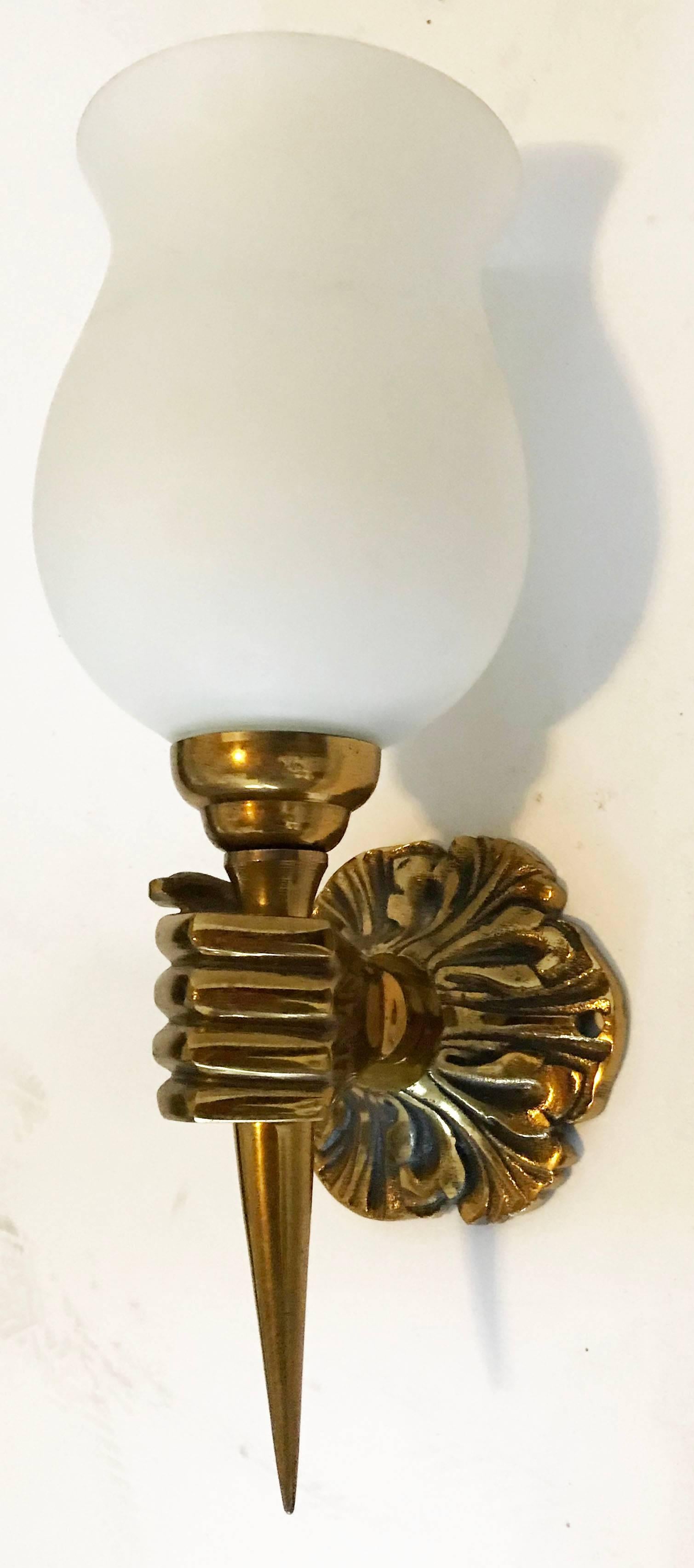 Bronze Arbus Bronze French sconces featuring a hand holding a torch. Opposite hands, circa 1940s
Measurements: 
Projection to the wall: 4.5 inches.
Back-plate: 3.5 inches diameter.
Width: 4.5 inches.
Original blown Opaline Glass shades.
