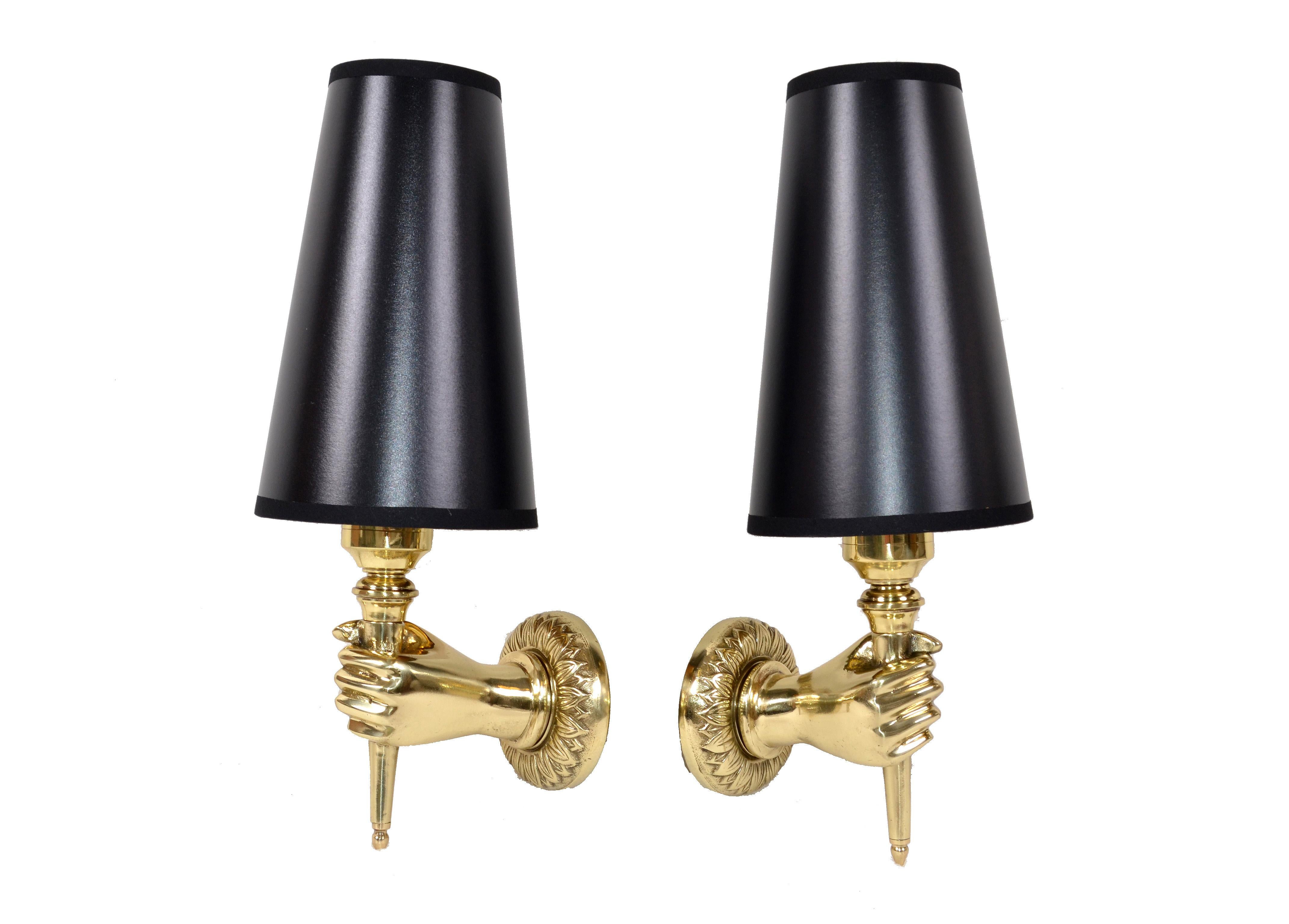 Superb pair of bronze hand sconces designed by André Arbus in France.
The pair comes with black and gold paper cone shade.
US rewiring and each takes one light bulb with max. 40 watts.
Back plate measures: 3.25 inches diameter
Shade measures: