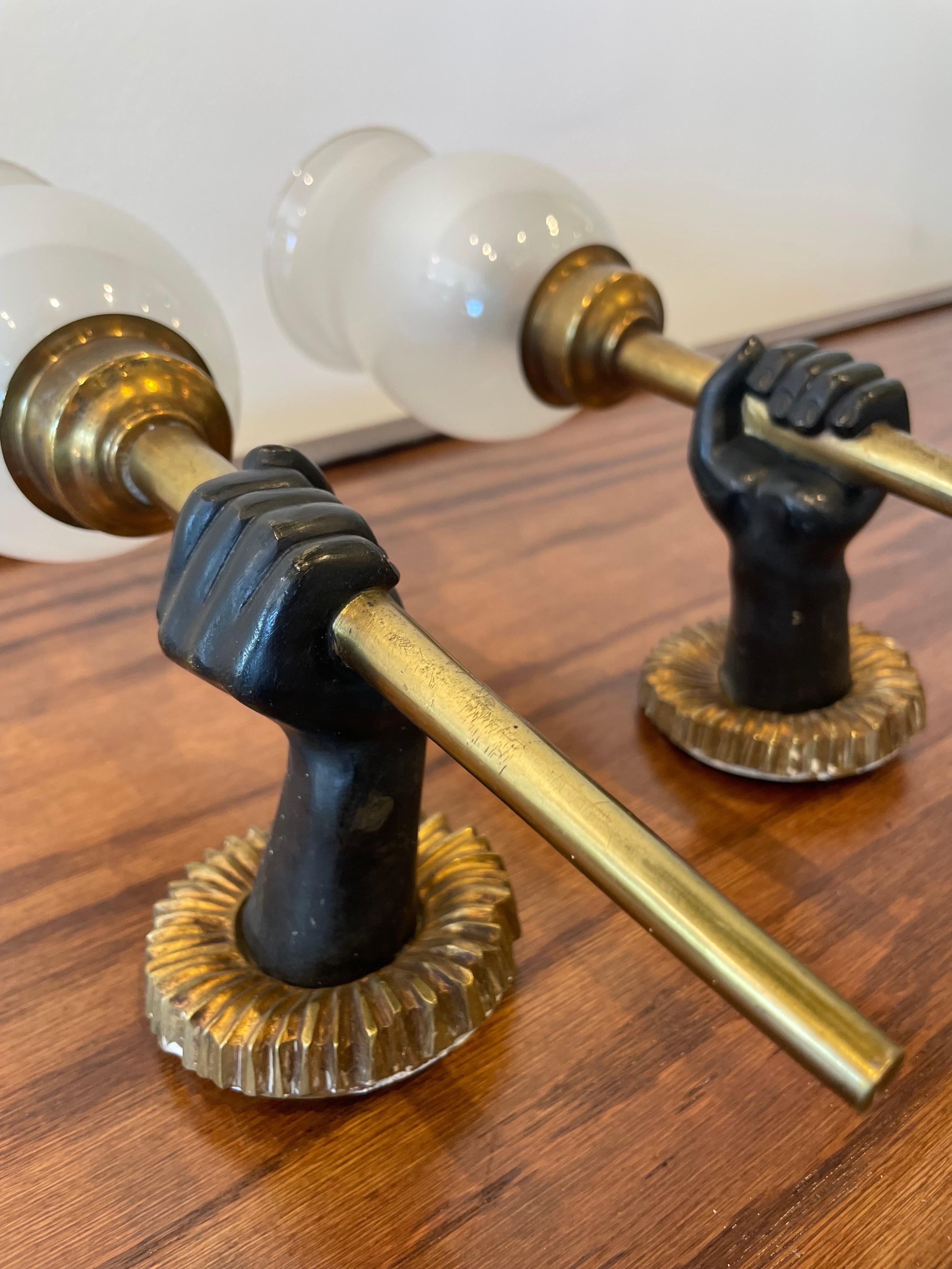 Bronze Andre Arbus wall sconces depicting hands holding torchieres, topped with their ORIGINAL frosted glass diffusers.