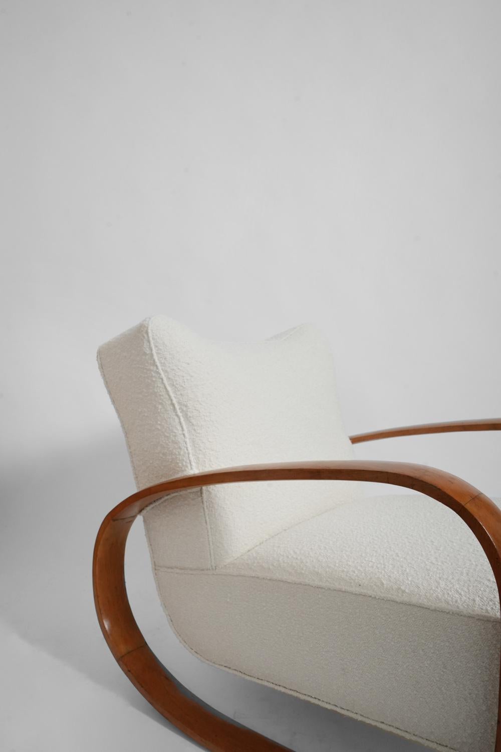 Rocking chair in light wood, orange fabrics with flowers, in the style of André Arbus. France, 1950s. 