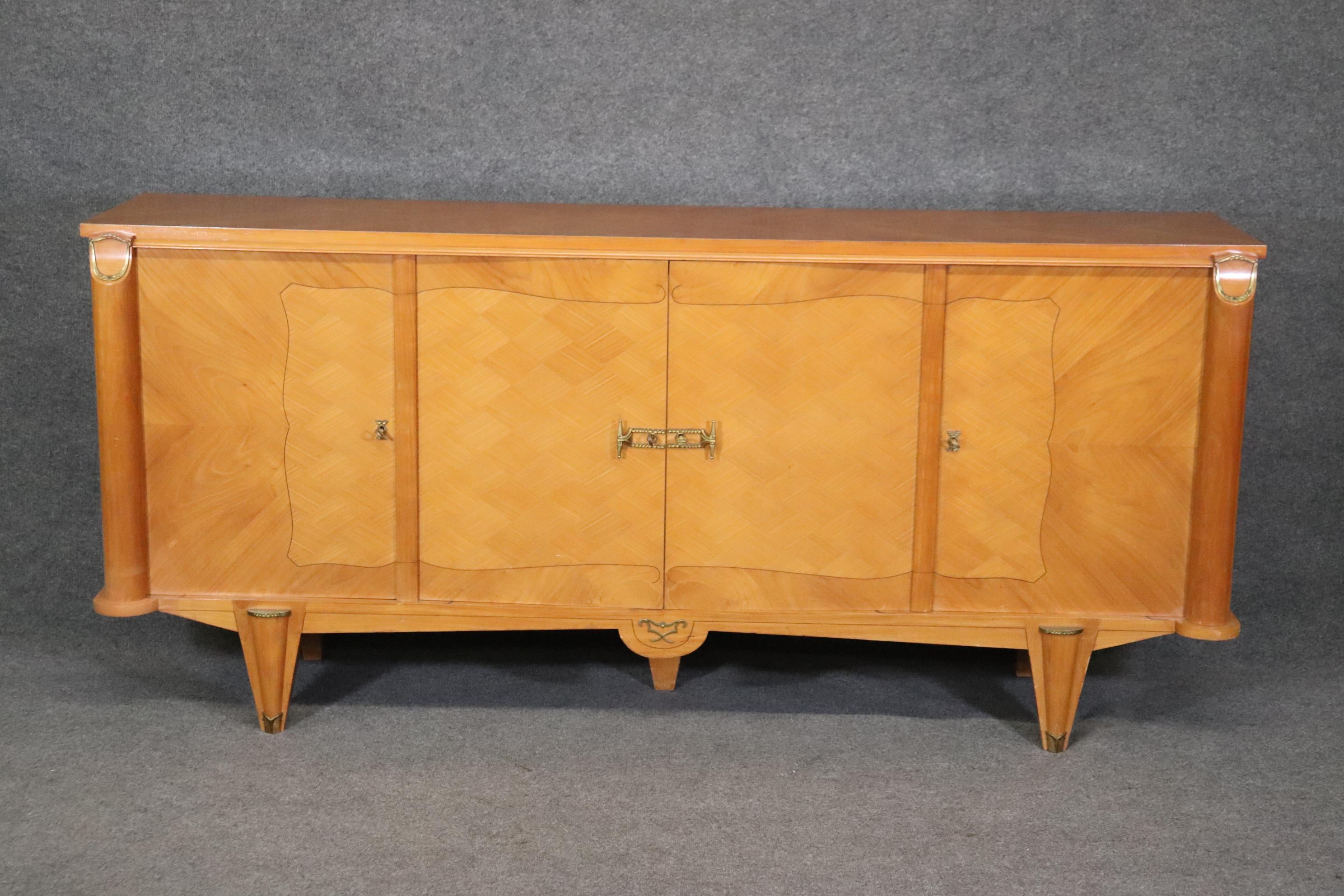 This is a fantastic 1940s era French Art Deco sideboard in the style of Andre Arbus. The piece was made in France and has matching pieces listed separatey. The piece is an incredible design in cherry and done with marquetry veneer. The dimensions