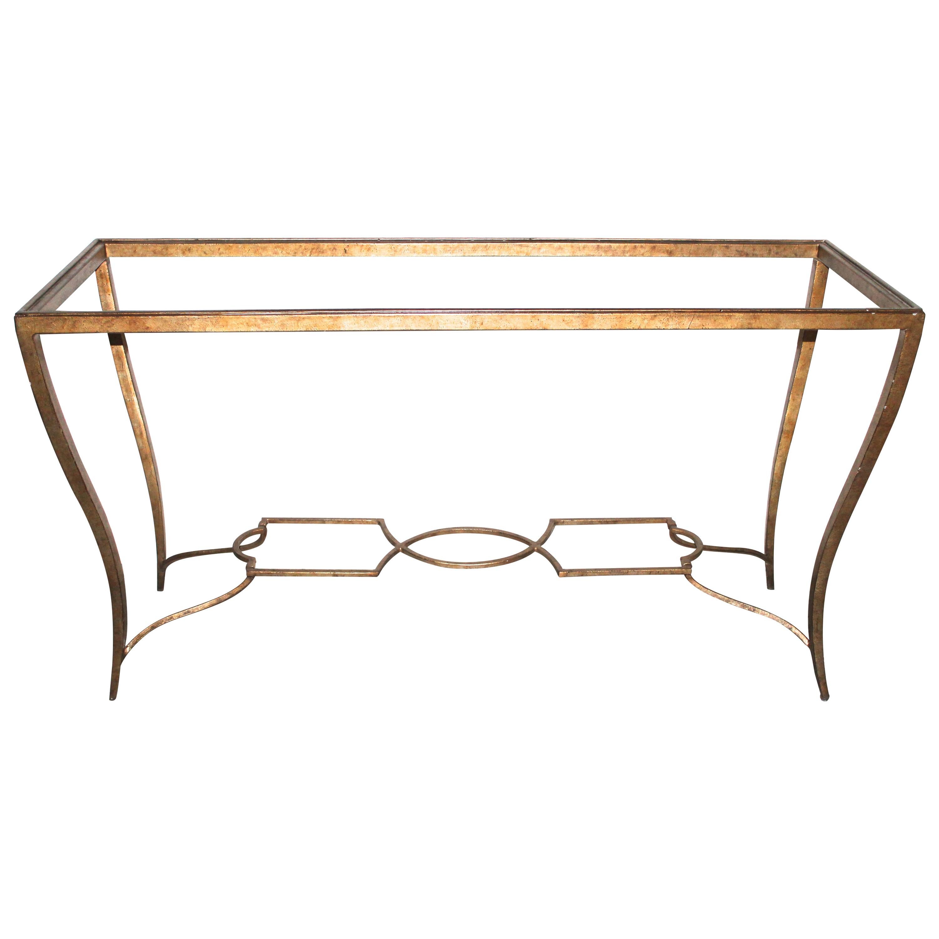 A beveled plate glass sits in a gilt painted wrought iron base with typical fluted curved Arbus signature legs, connected on the bottom with Classic shapes.